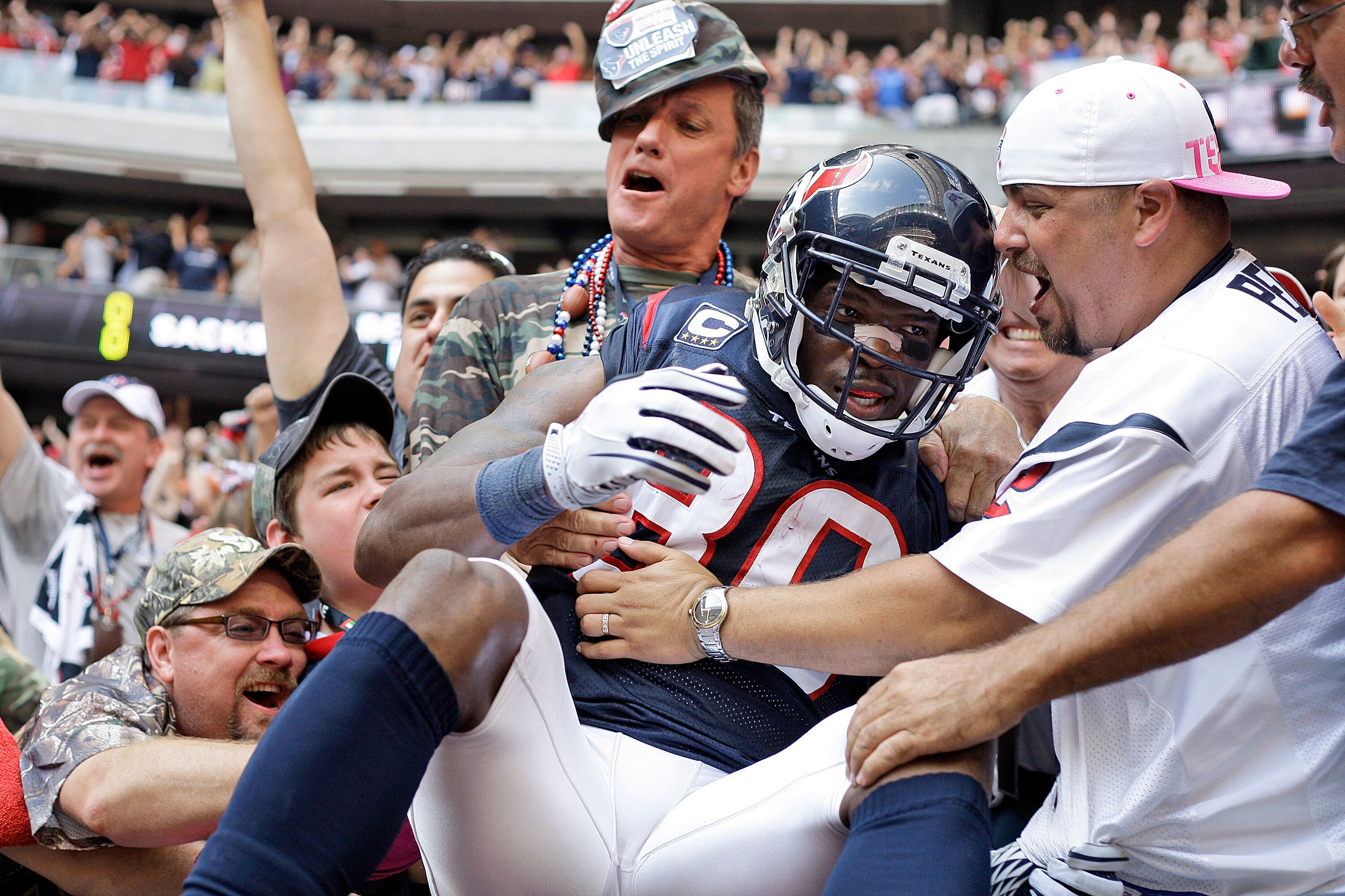 HOUSTON - OCTOBER 17:  Andre Johnson #80 of the Houston Texans is mobbed by fans after he scored the go ahead touchdown in the fourth quarter against the Kansas City Chiefs at Reliant Stadium on October 17, 2010 in Houston, Texas.  (Photo by Bob Levey/Get