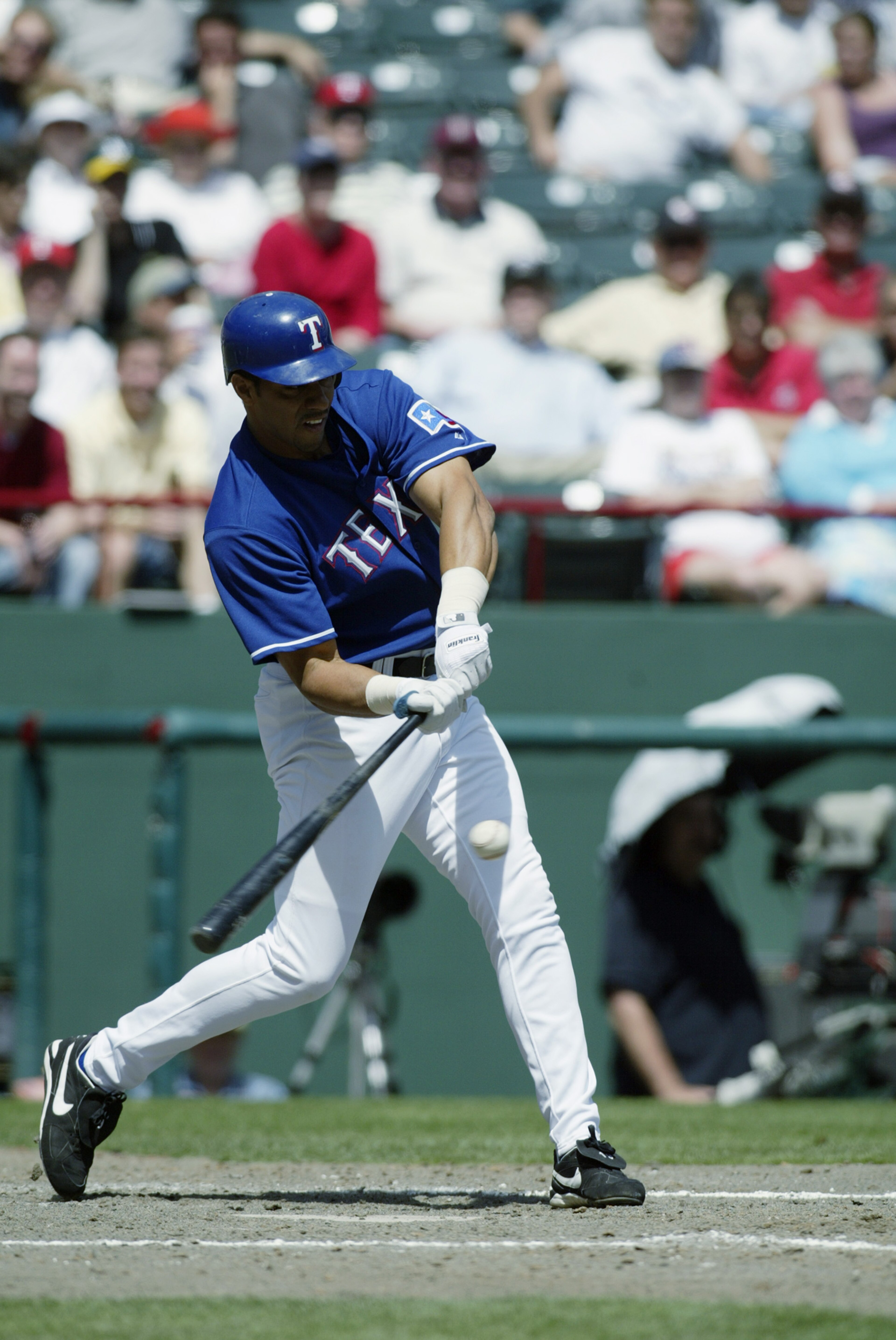 ARLINGTON, TX - APRIL 10:  Juan Gonzalez #19 of the Texas Rangers swings at a pitch during the game against the Oakland Athletics at the Ballpark in Arlington on April 10, 2003 in Arlington, Texas.  The Rangers defeated the A's 5-4.  (Photo by Ronald Mart