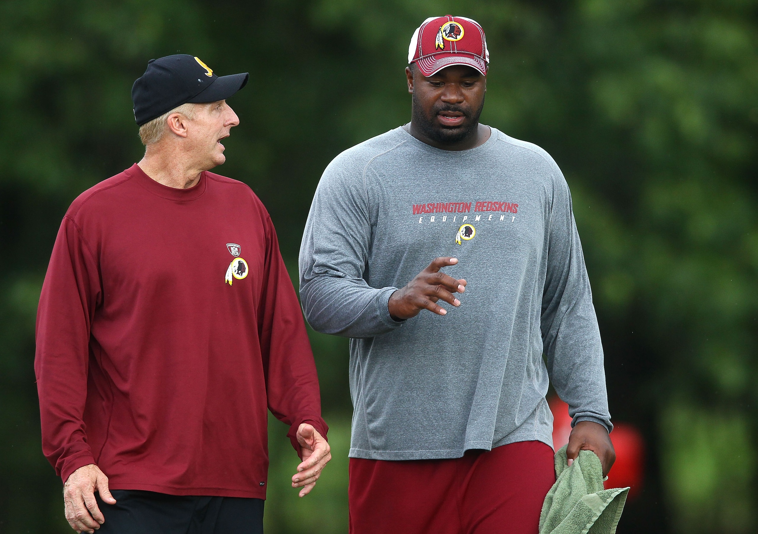 ASHBURN, VA - JULY 29:  Defensive lineman Albert Haynesworth #92 (R) walks with Defensive Coordinator Jim Haslett (L) after the Redskins first day of training camp on July 29, 2010 in Ashburn, Virginia.  (Photo by Win McNamee/Getty Images)
