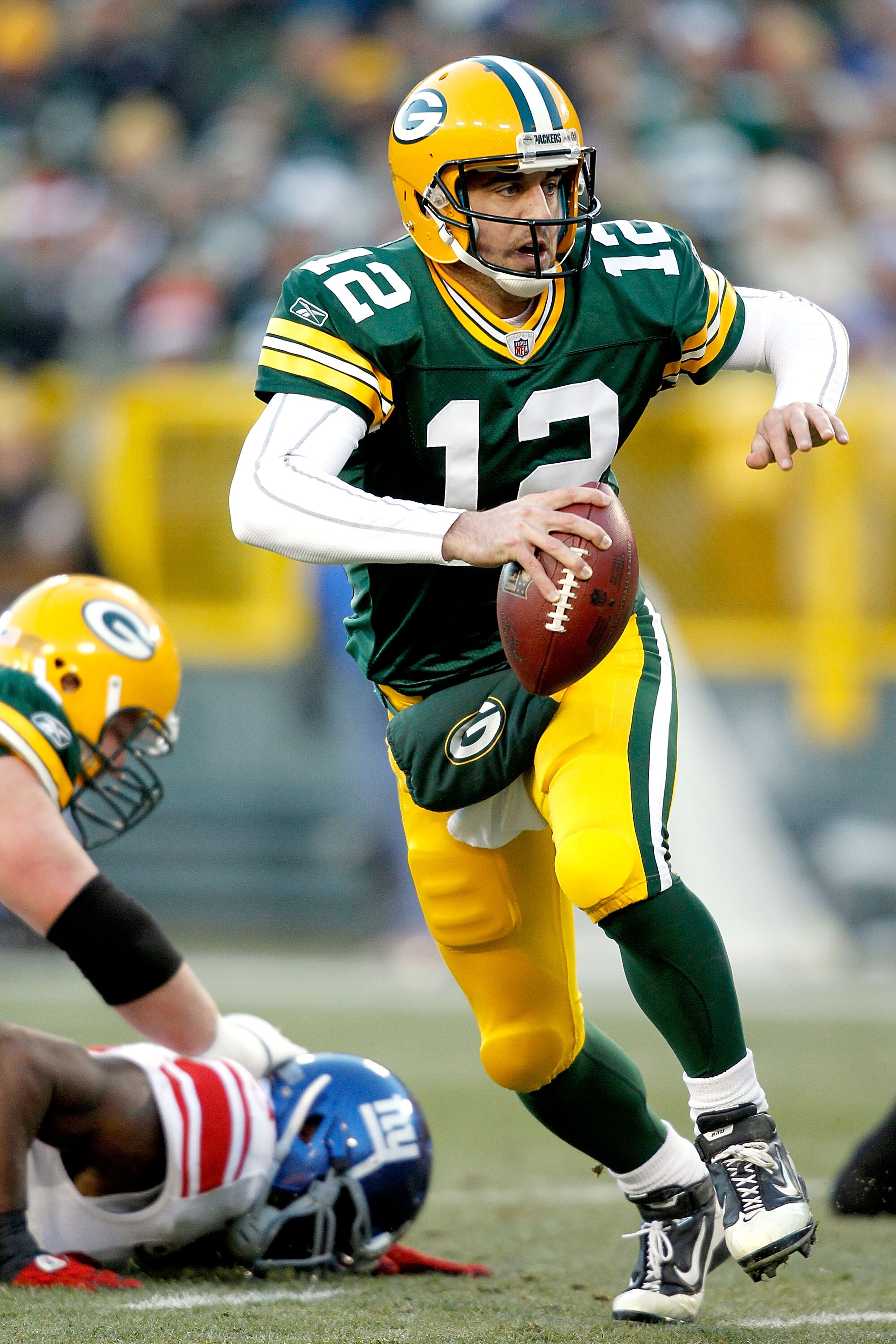 GREEN BAY, WI - DECEMBER 26: Aaron Rodgers #12 of the Green Bay Packers is chased out of the pocket against the New York Giants at Lambeau Field on December 26, 2010 in Green Bay, Wisconsin. (Photo by Matthew Stockman/Getty Images) GREEN BAY, WI - DECEMBER 26: Aaron Rodgers #12 of the Green Bay Packers is chased out of the pocket against the New York Giants at Lambeau Field on December 26, 2010 in Green Bay, Wisconsin. (Photo by Matthew Stockman/Getty Images)