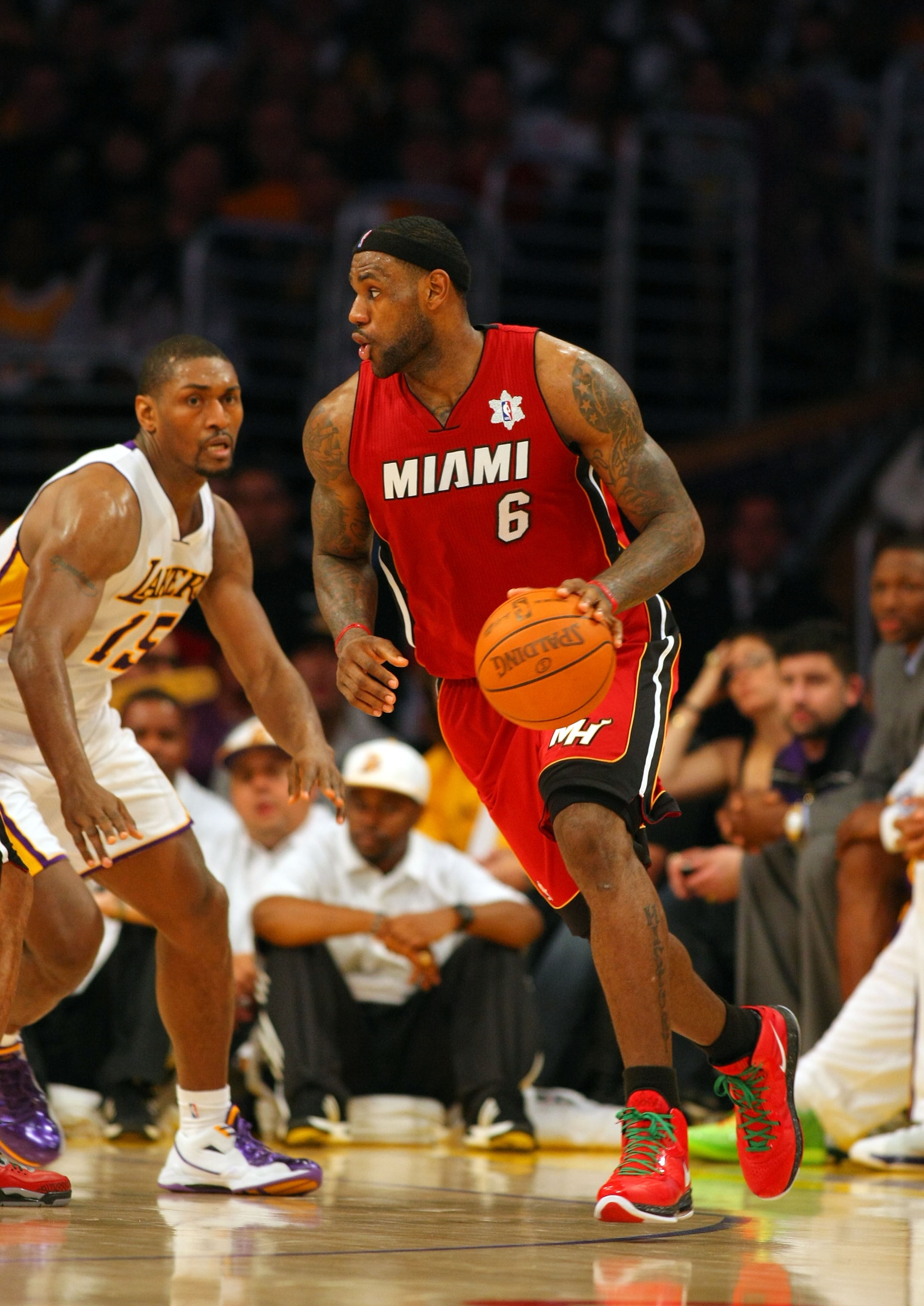 LOS ANGELES, CA - DECEMBER 25:  LeBron James #6 of the Miami Heat dribbles the ball along the perimeter against Ron Artest #15 of the Los Angeles Lakers during the NBA game at Staples Center on December 25, 2010 in Los Angeles, California. The Heat defeat