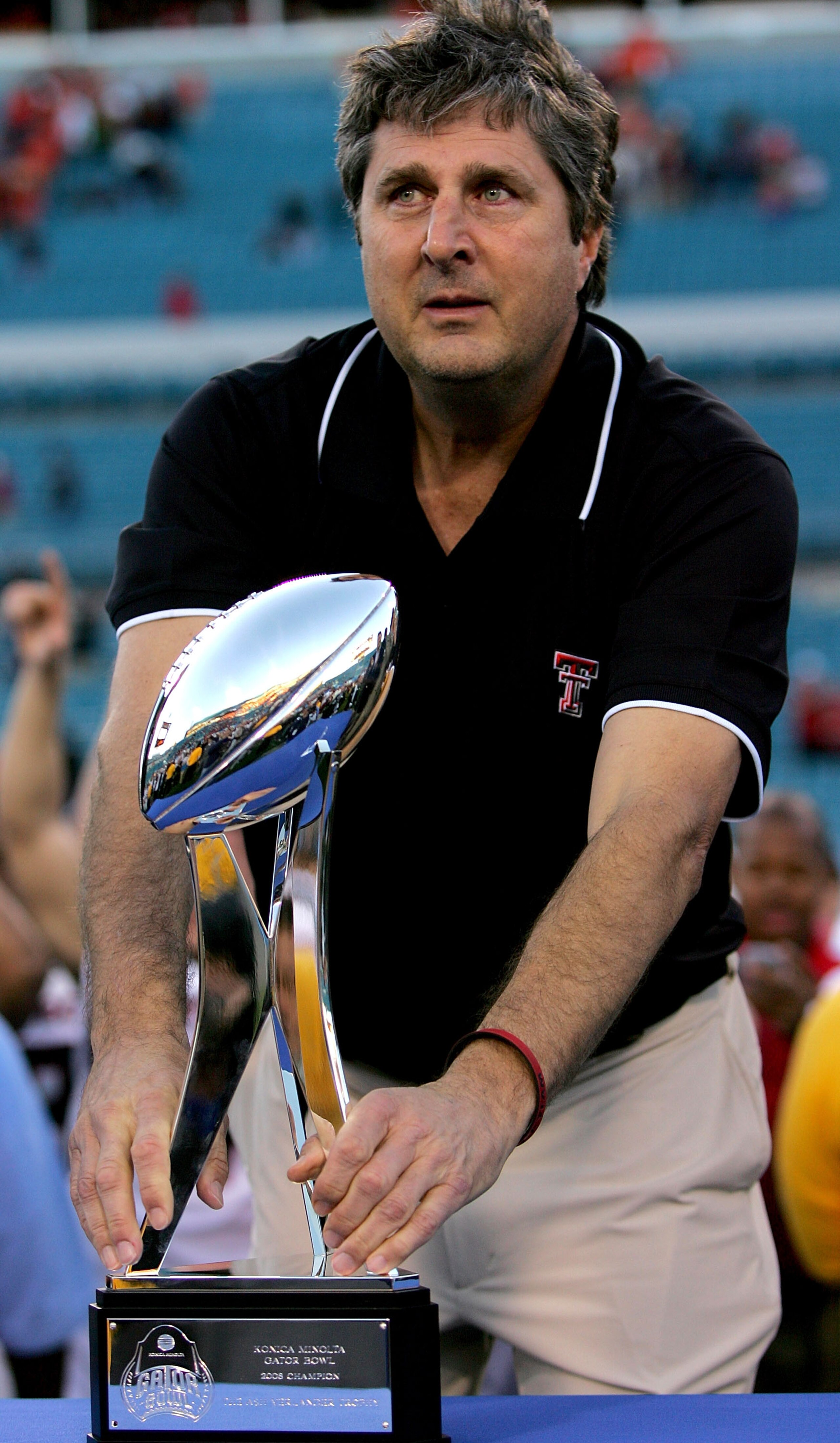 JACKSONVILLE, FL - JANUARY 01:  Coach Mike Leach of the Texas Tech Red Raiders holds the trophy following Gator Bowl against the Virginia Cavaliers at Jacksonville Municipal Stadium on January 1, 2008 in Jacksonville, Florida.  (Photo by Sam Greenwood/Get