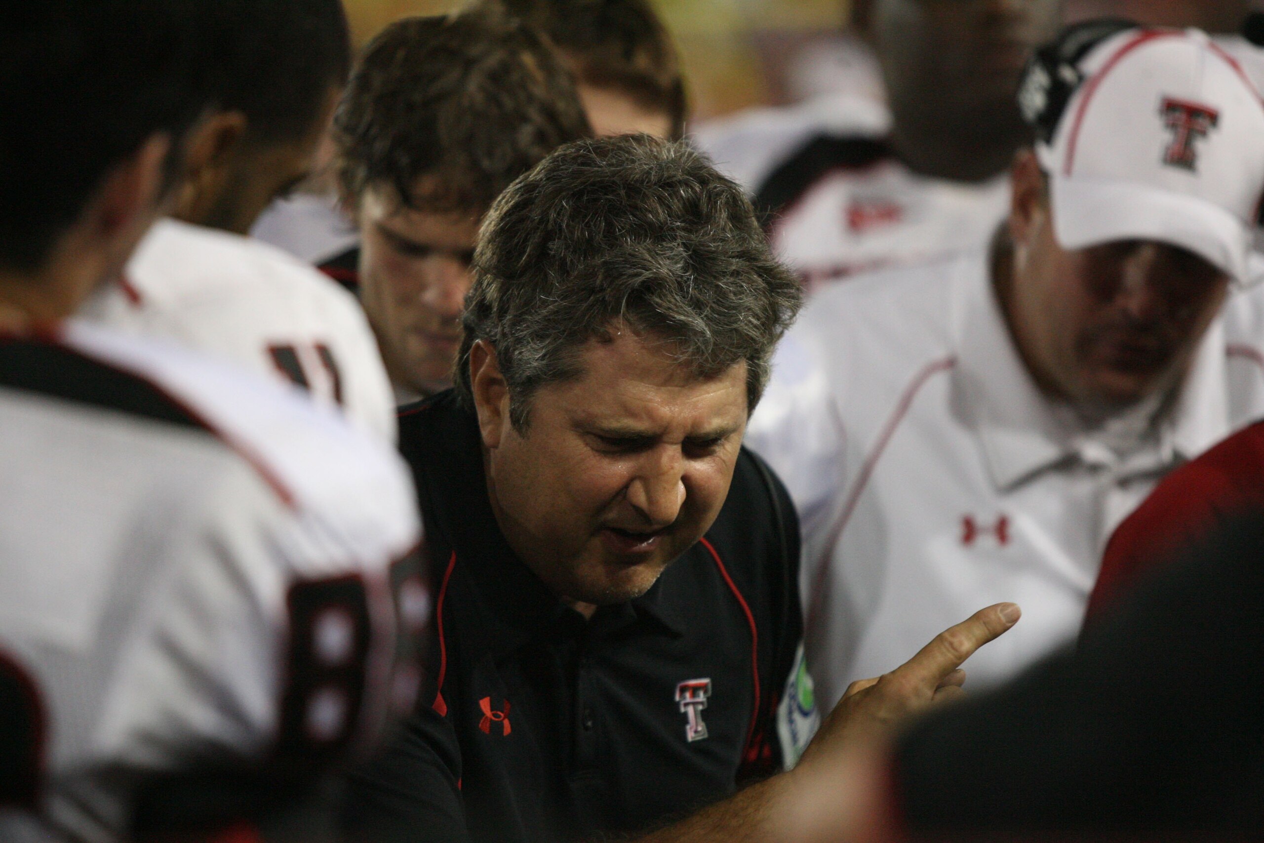 HOUSTON - SEPTEMBER 26:  Head coach Mike Leach of the Texas Tech Red Raiders talks with his defense while playing against the University of Houston at Robertson Stadium on September 26, 2009 in Houston, Texas.  (Photo by Thomas B. Shea/Getty Images)