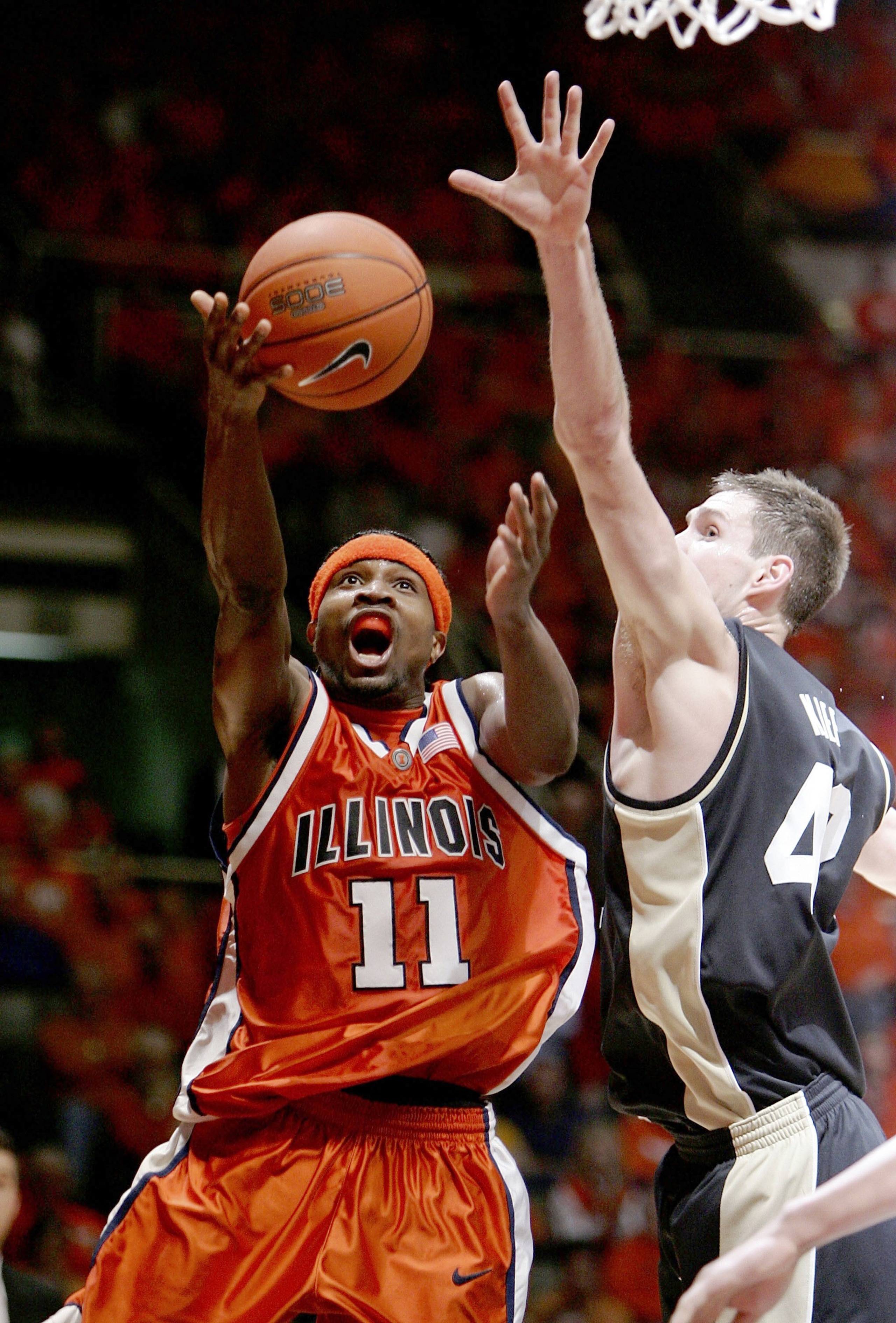 CHAMPAIGN, IL - JANUARY 28:  Dee Brown #11 of the Illinois Fighting Illini puts up a shot against Matt Kiefer #42 of the Purdue Boilermakers on January 28, 2006 at the Assembly Hall at the University of Illinois in Champaign, Illinois. Illinois defeated P