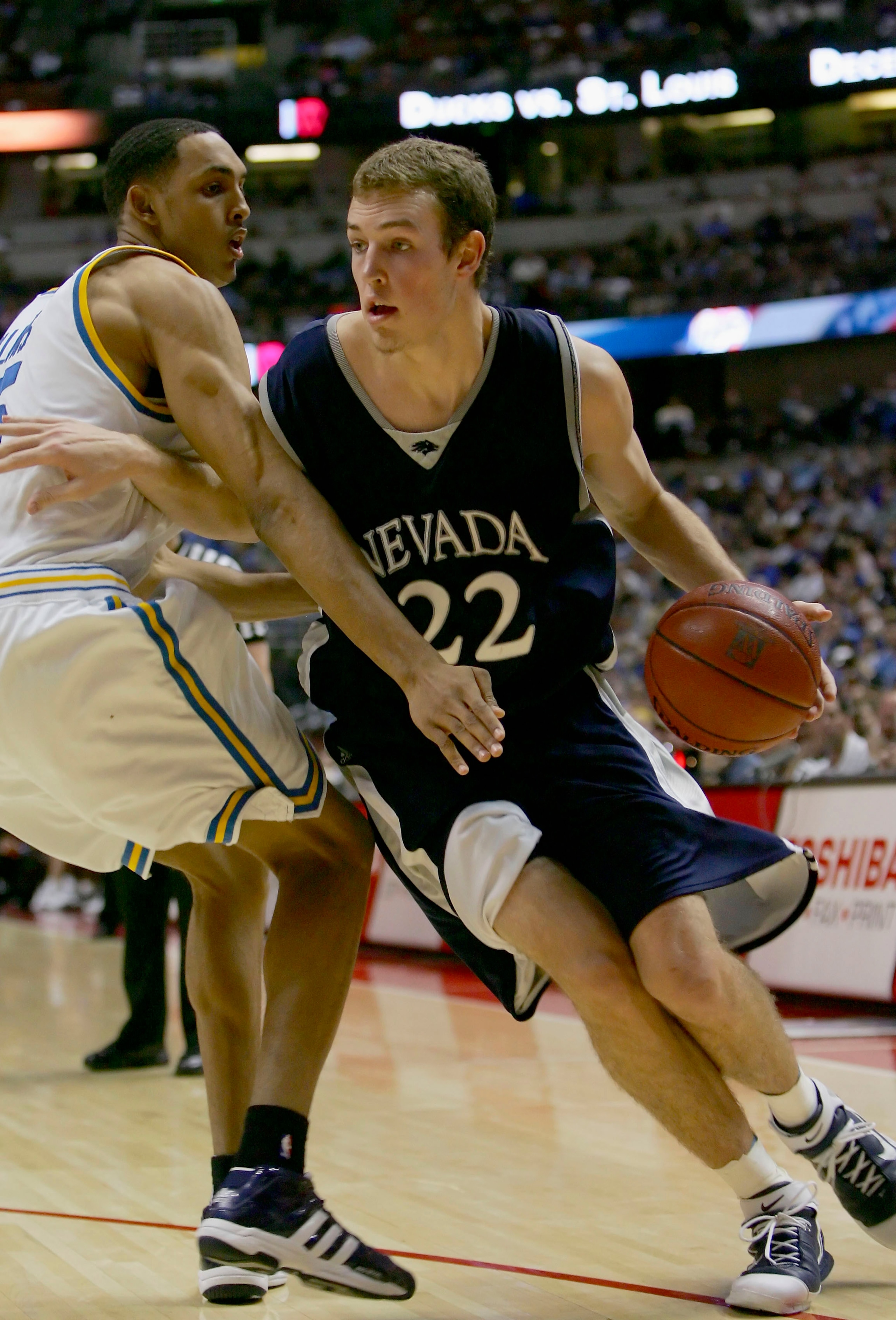 ANAHEIM, CA - DECEMBER 10:  Nick Fazekas #22 of the Nevada Wolf Pack drives to the basket against Ryan Hollins #15 of the UCLA Bruins during the 12th Annual John R. Wooden Classic on December 10, 2005 at Arrowhead Pond of Anaheim in Anaheim, California.