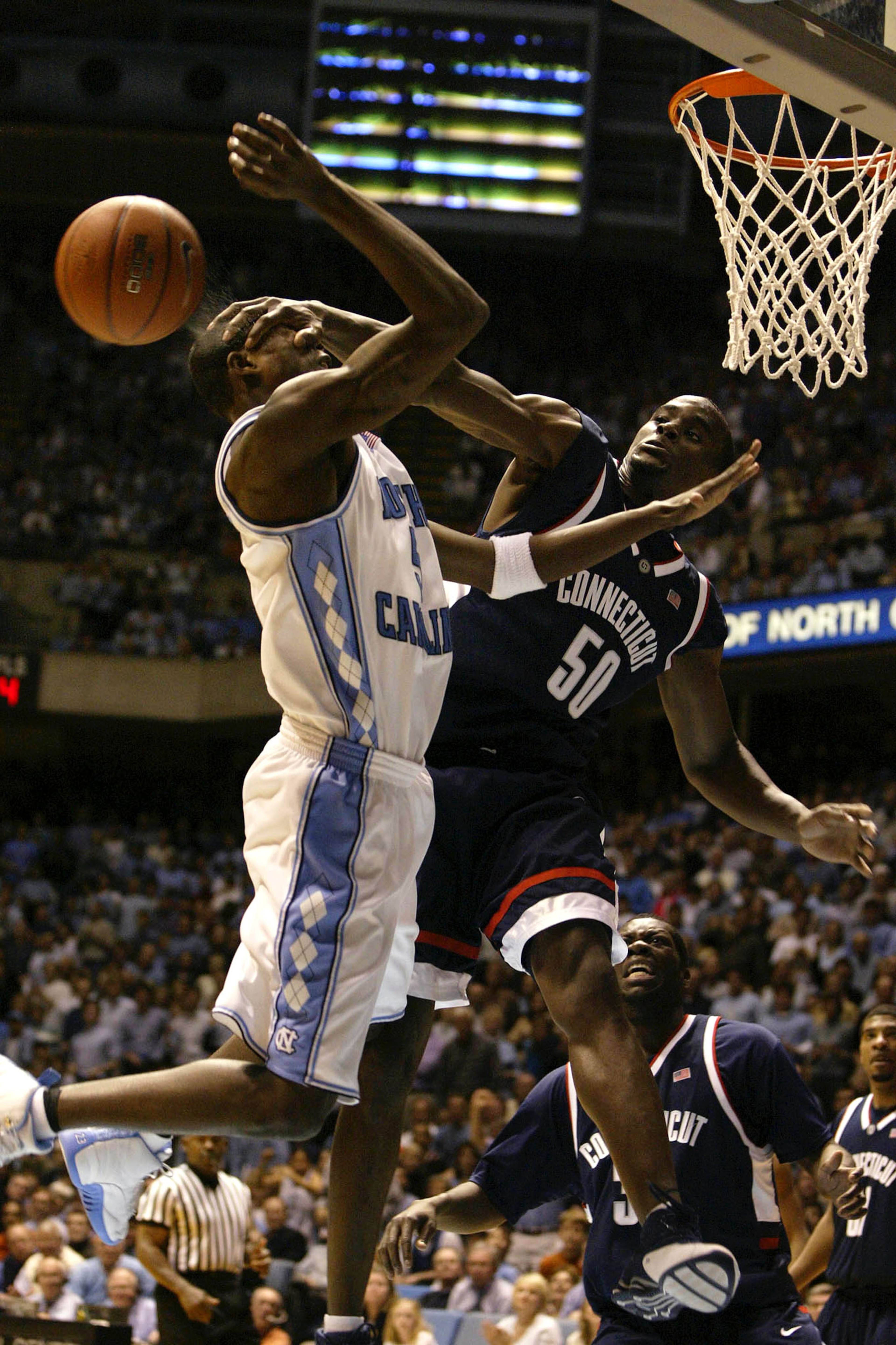 CHAPEL HILL, NC - JANUARY 17: Emeka Okafor #50 of the University of Connecticut Huskies hits Jackie Manuel #5 of the University of North Carolina Tar Heels in the face during their game January 17, 2004 at the Dean E. Smith Center in Chapel Hill, North C CHAPEL HILL, NC - JANUARY 17: Emeka Okafor #50 of the University of Connecticut Huskies hits Jackie Manuel #5 of the University of North Carolina Tar Heels in the face during their game January 17, 2004 at the Dean E. Smith Center in Chapel Hill, North C