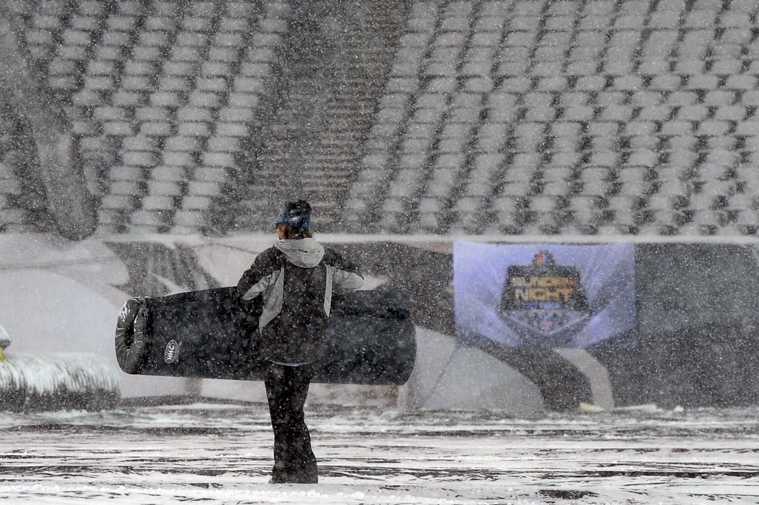 PHILADELPHIA - DECEMBER 26: a Philadelphia Eagles ground crew worker carries padding across the field at Lincoln Financial Field on December 26, 2010 in Philadelphia, Pennsylvania. The game between the Minnesota Vikings and Philadelphia Eagles was postpon