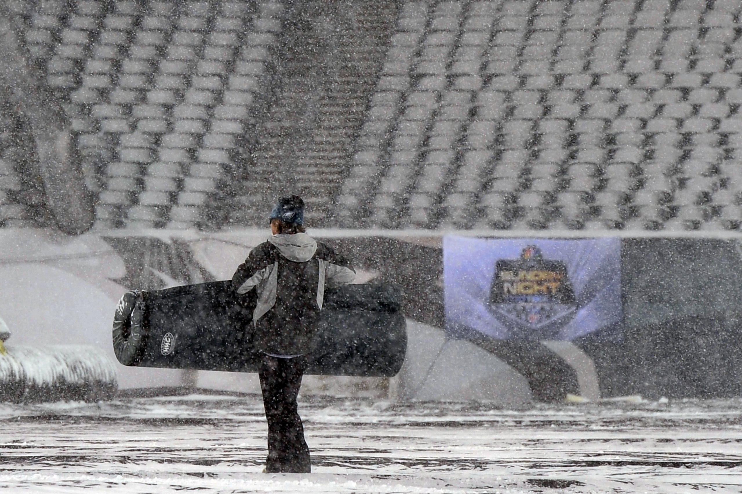 PHILADELPHIA - DECEMBER 26: a Philadelphia Eagles ground crew worker carries padding across the field at Lincoln Financial Field on December 26, 2010 in Philadelphia, Pennsylvania. The game between the Minnesota Vikings and Philadelphia Eagles was postpon