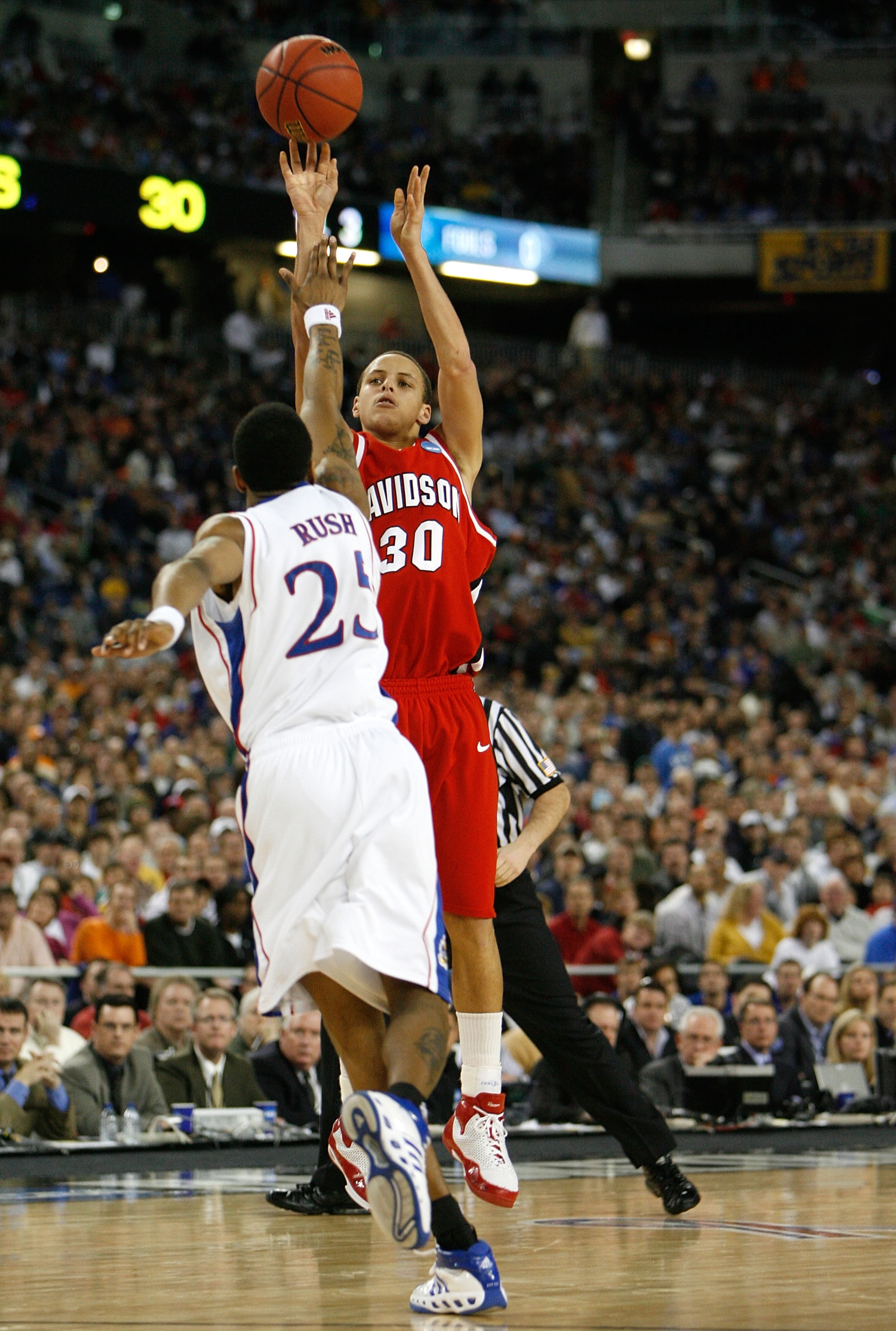 DETROIT - MARCH 30:  Stephen Curry #30 of the Davidson Wildcats attempts a shot against Brandon Rush #25 of the Kansas Jayhawks during the Midwest Regional Final of the 2008 NCAA Division I Men's Basketball Tournament at Ford Field on March 30, 2008 in De