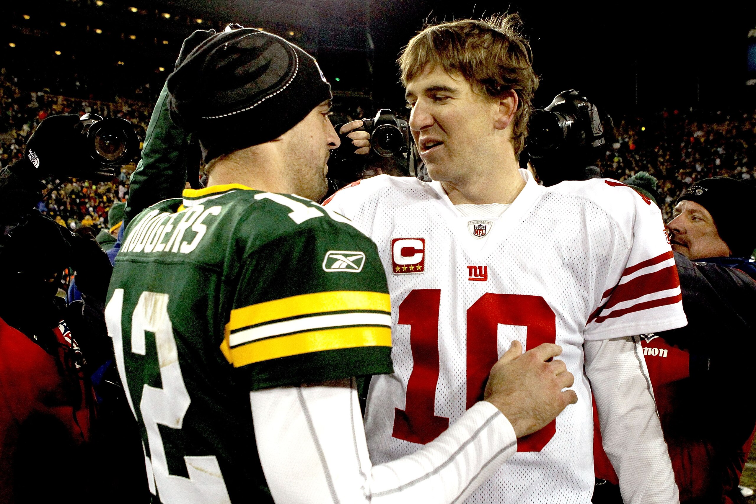 GREEN BAY, WI - DECEMBER 26:  Aaron Rodgers #12 of the Green Bay Packers is congratulated by Eli Manning #10 of the New York Giants after their game at Lambeau Field on December 26, 2010 in Green Bay, Wisconsin.  (Photo by Matthew Stockman/Getty Images)
