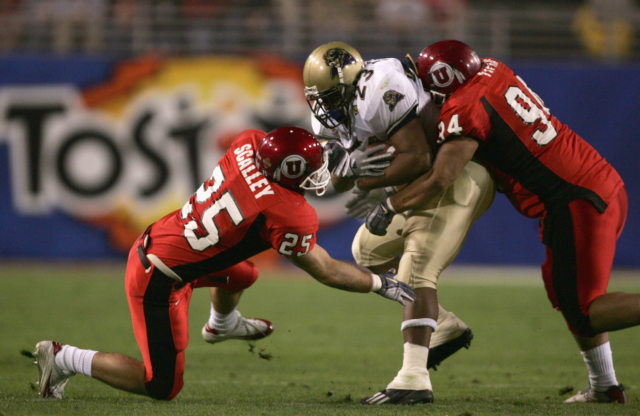 TEMPE, AZ - JANUARY 1: Tim Murphy #23 of Pittsburgh is stopped by Steve Fifita #94 (R) and Morgan Scalley #25 (L) of Utah during the Tostito's Fiesta Bowl at the Sun Devil Stadium on January 1, 2005 in Tempe, Arizona. Utah won the game with the score of TEMPE, AZ - JANUARY 1: Tim Murphy #23 of Pittsburgh is stopped by Steve Fifita #94 (R) and Morgan Scalley #25 (L) of Utah during the Tostito's Fiesta Bowl at the Sun Devil Stadium on January 1, 2005 in Tempe, Arizona. Utah won the game with the score of