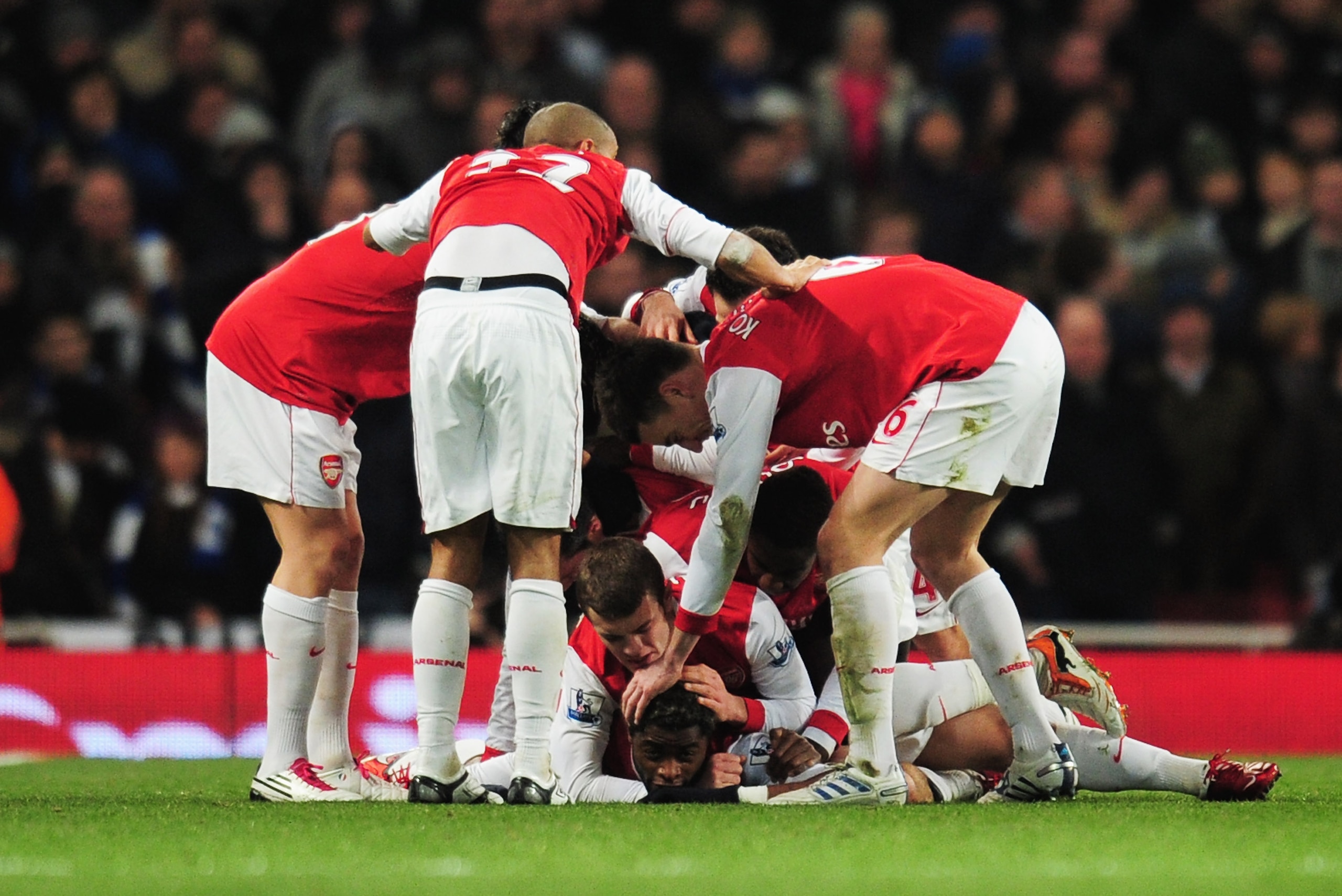 LONDON, ENGLAND - DECEMBER 27:  Alex Song of Arsenal is mobbed by team mates after scoring the opening goal during the Barclays Premier League match between Arsenal and Chelsea at the Emirates Stadium on December 27, 2010 in London, England.  (Photo by Sh