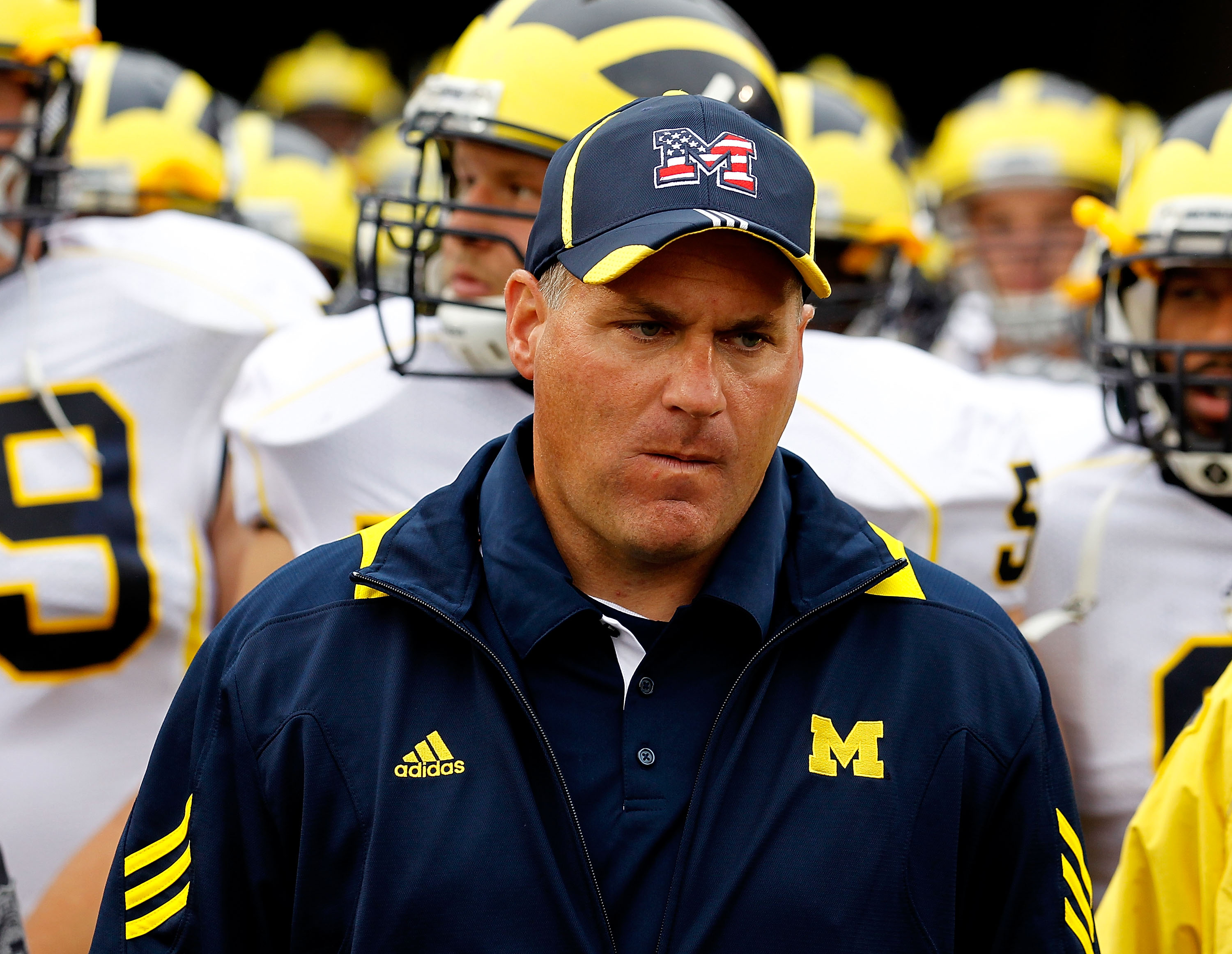 SOUTH BEND, IN - SEPTEMBER 11: Head coach Rich Rodriguez of the Michigan Wolverines waits with his team before entering the field for a game against the Notre Dame Fighting Irish at Notre Dame Stadium on September 11, 2010 in South Bend, Indiana. Michigan