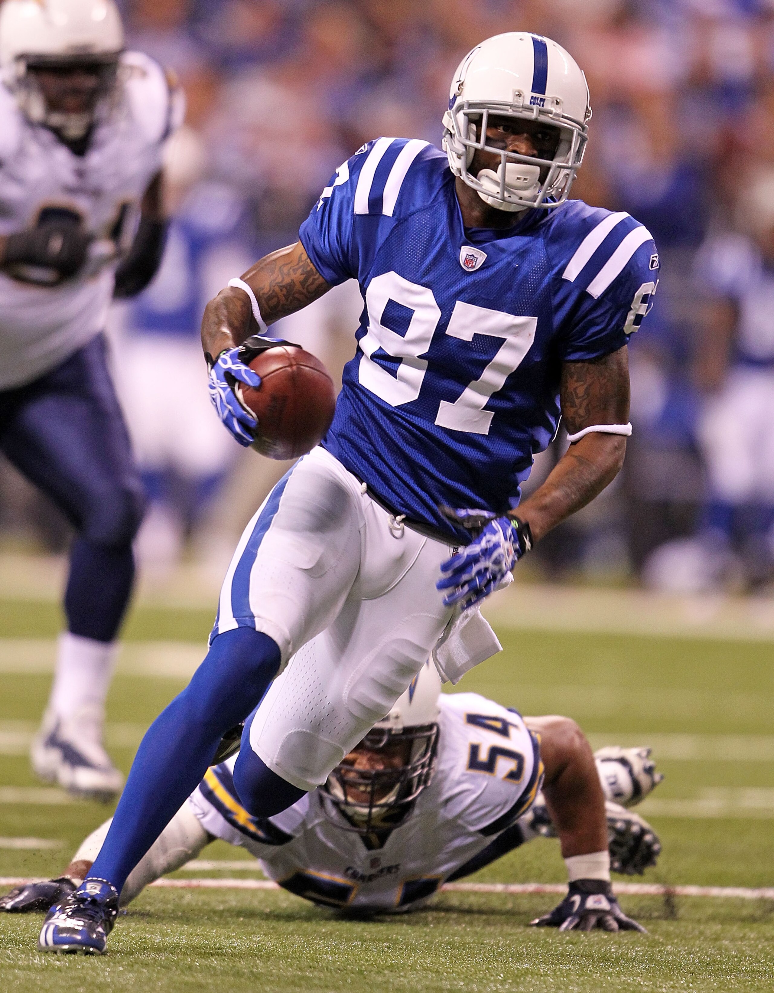 INDIANAPOLIS - NOVEMBER 28: Reggie Wayne #87 of the Indianapolis Colts runs with the ball during the NFL game against the San Diego Chargers at Lucas Oil Stadium on November 28, 2010 in Indianapolis, Indiana. (Photo by Andy Lyons/Getty Images) INDIANAPOLIS - NOVEMBER 28: Reggie Wayne #87 of the Indianapolis Colts runs with the ball during the NFL game against the San Diego Chargers at Lucas Oil Stadium on November 28, 2010 in Indianapolis, Indiana. (Photo by Andy Lyons/Getty Images)