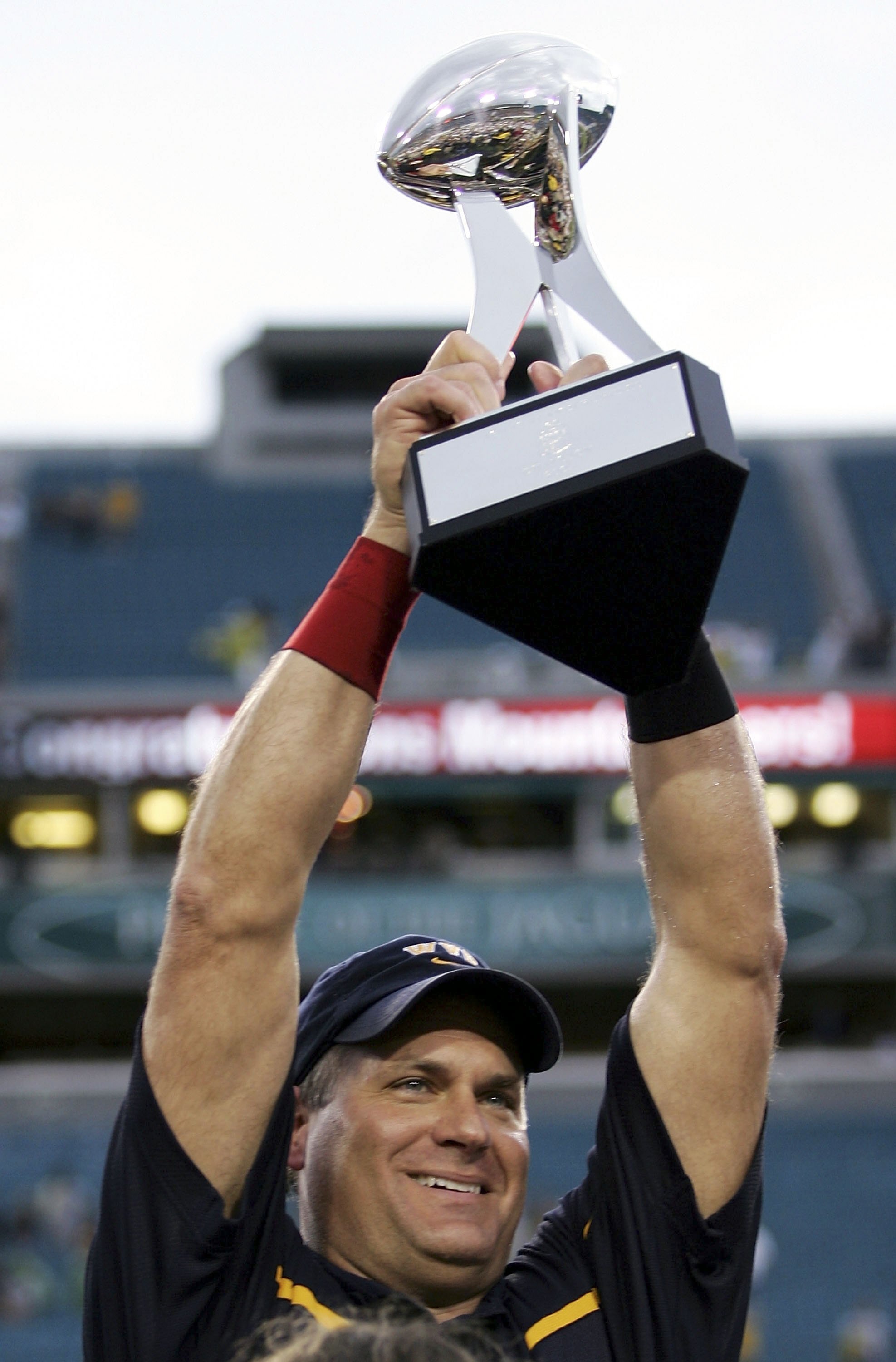 JACKSONVILLE, FL - JANUARY 01:  Head coach Rich Rodriguez of the West Virginia Mountaineers holds up the trophy after defeating the Georgia Tech Yellow Jackets 38-35 in the Toyota Gator Bowl at Alltel Stadium January 1, 2007 in Jacksonville, Florida.  (Ph