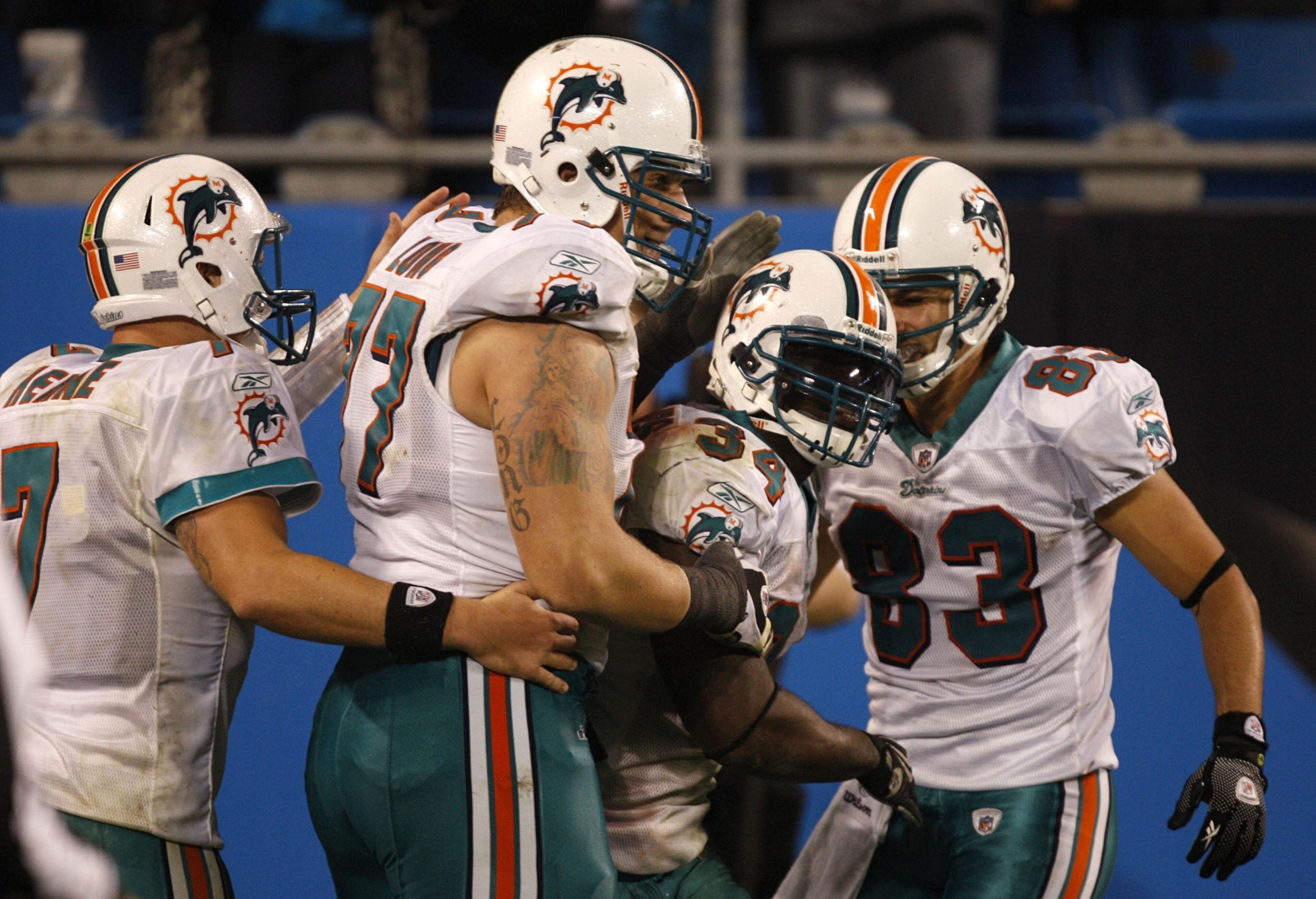 CHARLOTTE - NOVEMBER 19: (L-R) Chad Henne #7 Jake Long #77, Ricky Williams #34 and Greg Camarillo #83 of the Miami Dolphins celebrate after Williams scored a 46 yard rushing touchdown against the Carolina Panthers at Bank of America Stadium on November 19