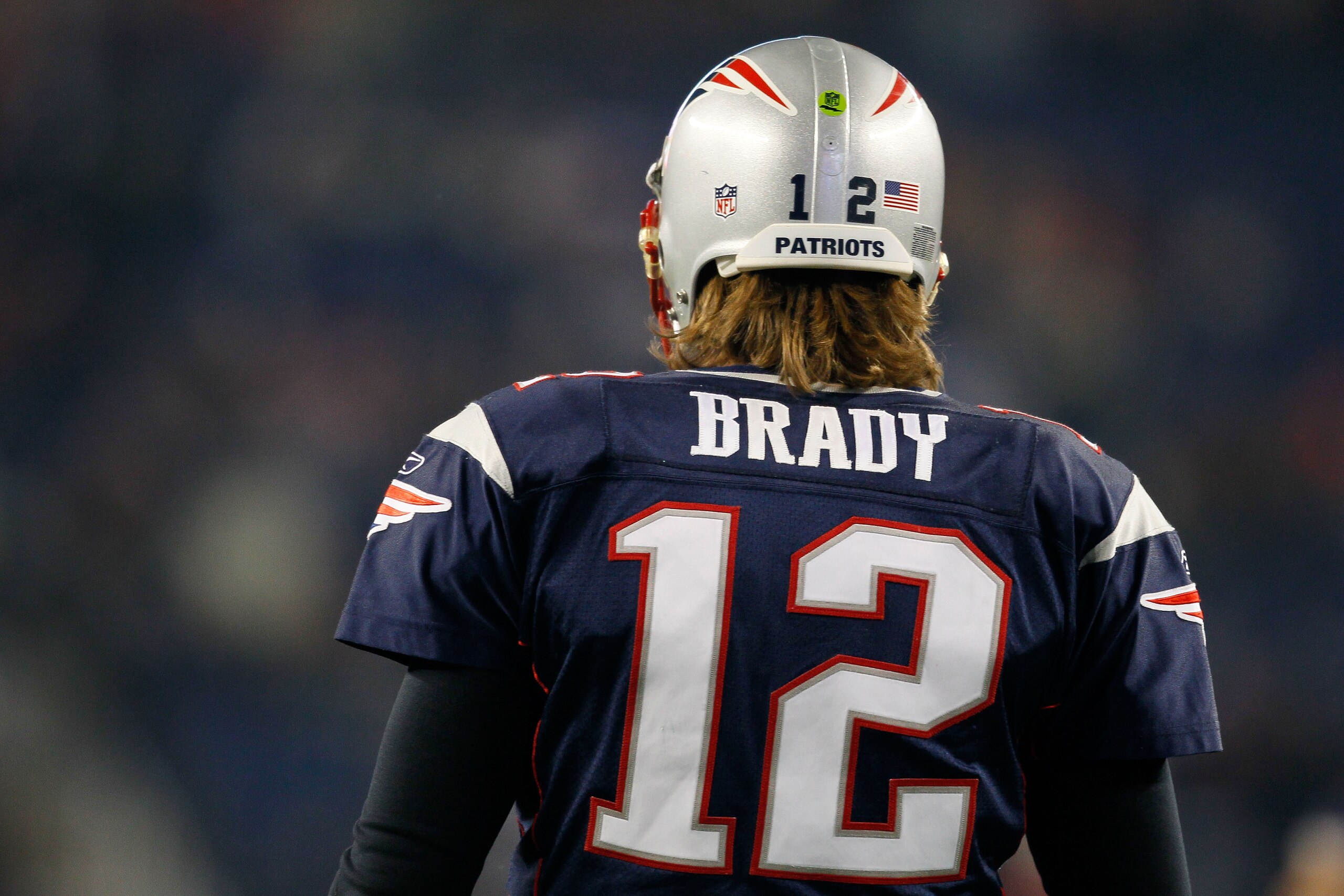 FOXBORO, MA - DECEMBER 19:  Quarterback Tom Brady #12 of the New England Patriots looks on during warm-ups before playing against the Green Bay Packers at Gillette Stadium on December 19, 2010 in Foxboro, Massachusetts.  (Photo by Jim Rogash/Getty Images)