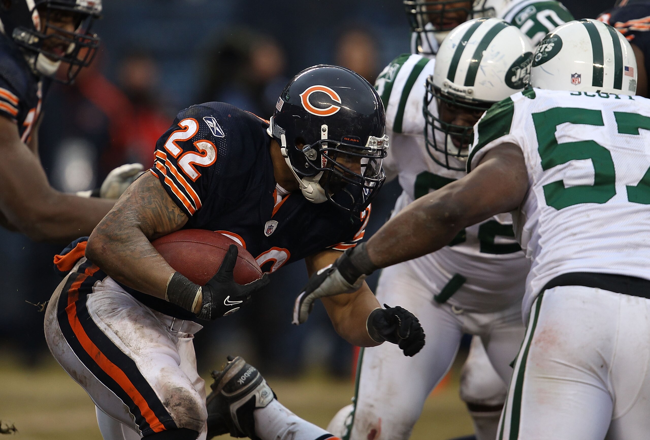 CHICAGO, IL - DECEMBER 26: Matt Forte #22 of the Chicago Bears runs against Bart Scott #57 and Shaun Ellis #92 of the New York Jets at Soldier Field on December 26, 2010 in Chicago, Illinois. The Bears defeated the Jets 38-34. (Photo by Jonathan Daniel/Ge