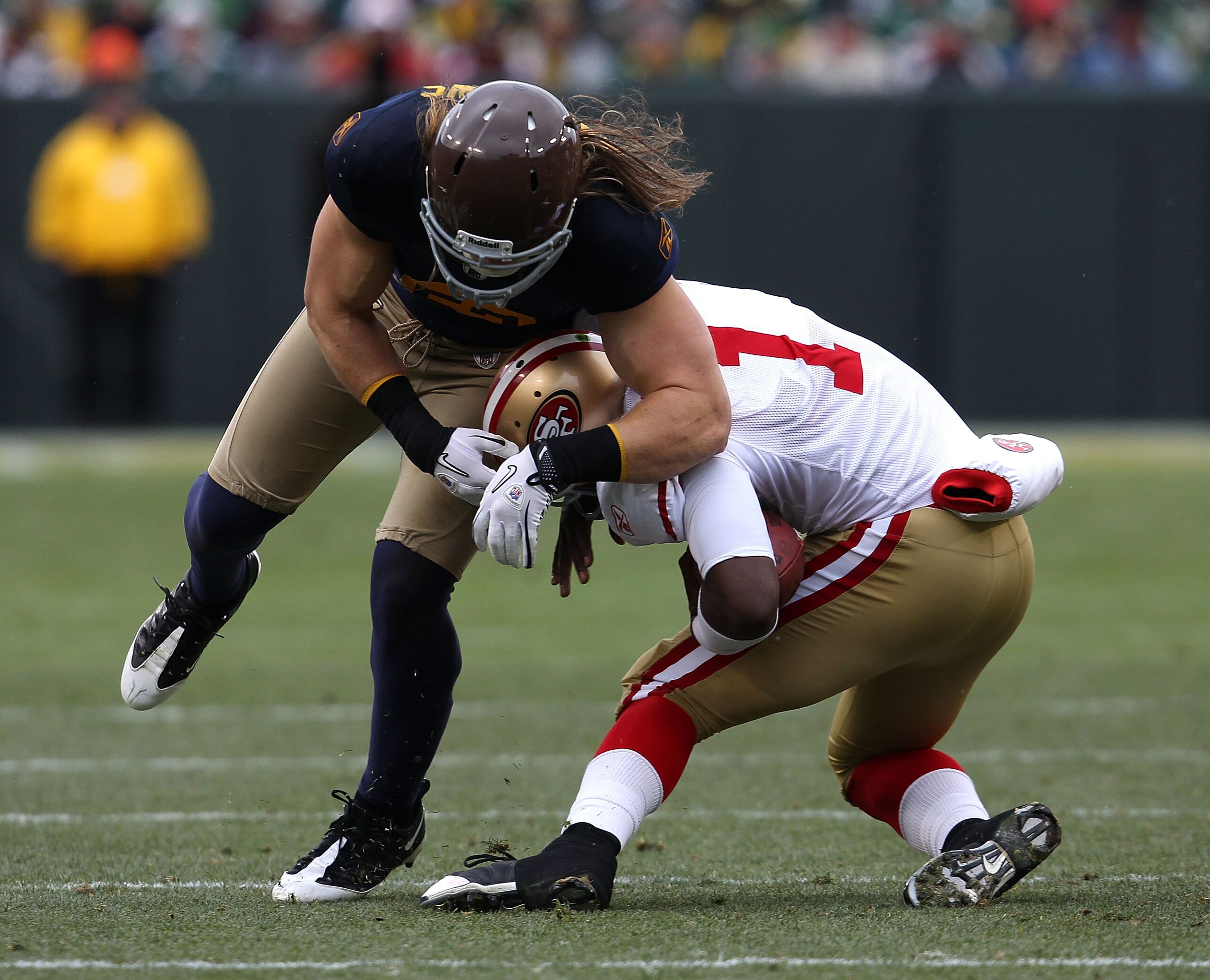 GREEN BAY, WI - DECEMBER 05: Troy Smith #1 of the San Francisco 49ers is tackled by Clay Matthews #52 of the Green Bay Packers at Lambeau Field on December 5, 2010 in Green Bay, Wisconsin. The Packers defeated the 49ers 34-16. (Photo by Jonathan Daniel/Ge