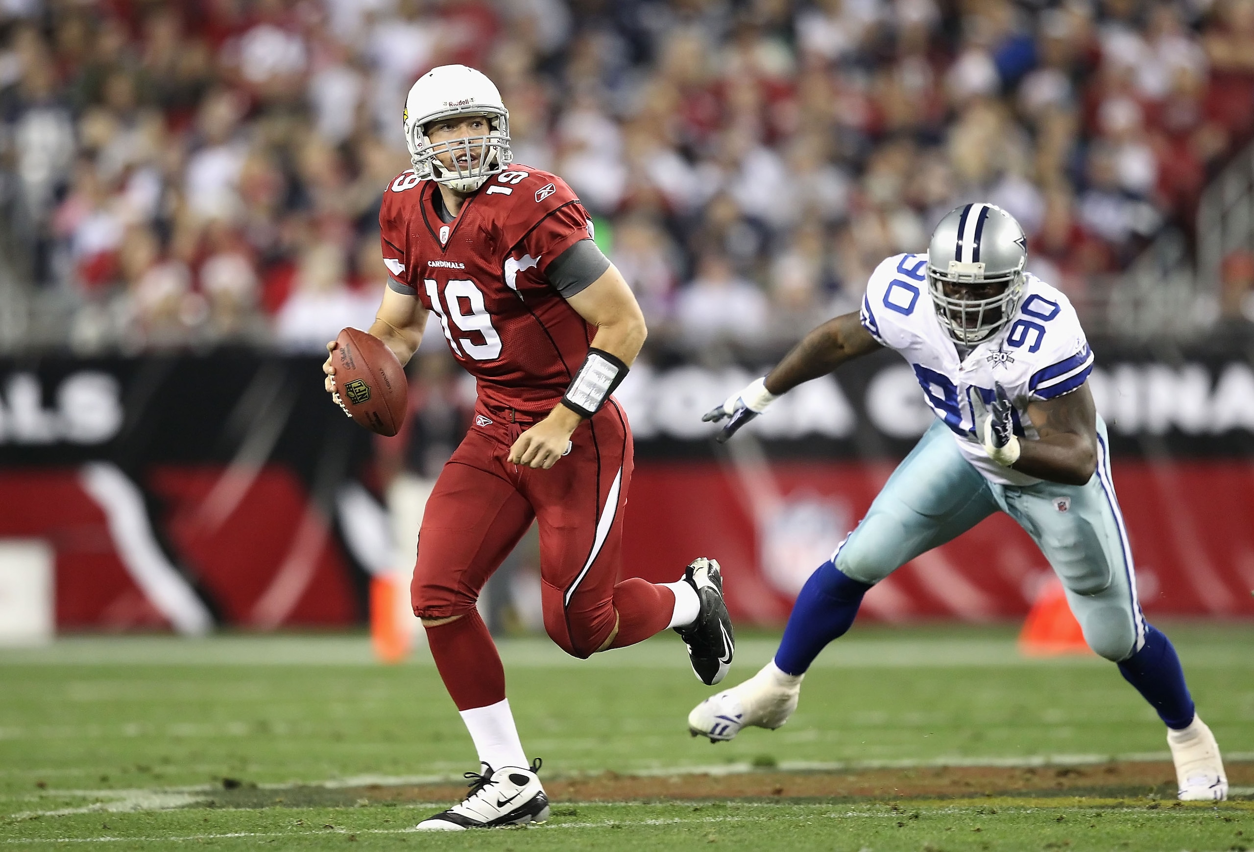 GLENDALE, AZ - DECEMBER 25: Quarterback John Skelton #19 of the Arizona Cardinals scrambles with the ball past Jay Ratliff #90 of the Dallas Cowboys during the NFL game at the University of Phoenix Stadium on December 25, 2010 in Glendale, Arizona. The C GLENDALE, AZ - DECEMBER 25: Quarterback John Skelton #19 of the Arizona Cardinals scrambles with the ball past Jay Ratliff #90 of the Dallas Cowboys during the NFL game at the University of Phoenix Stadium on December 25, 2010 in Glendale, Arizona. The C