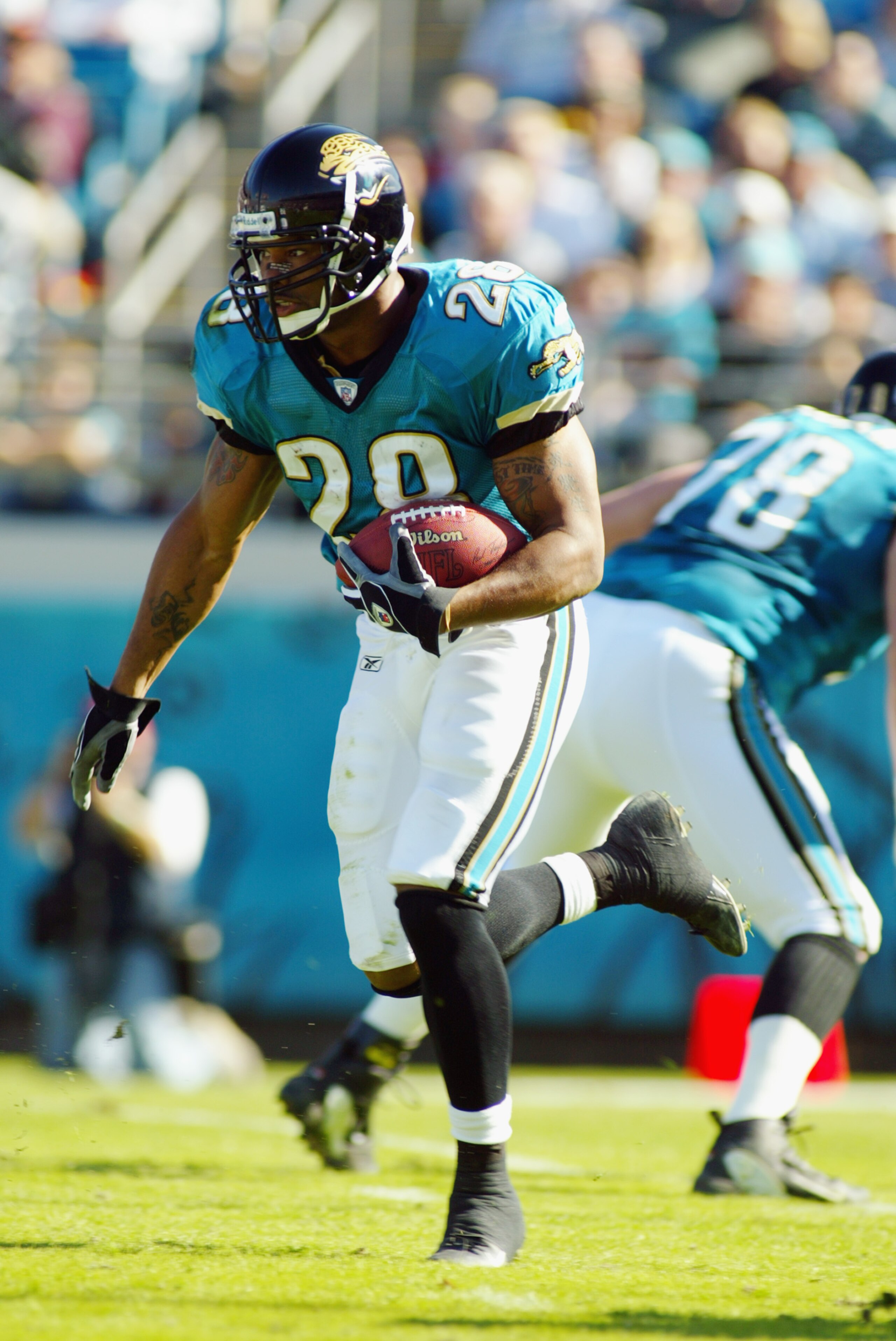 JACKSONVILLE, FL - DECEMBER 22: Running back Fred Taylor #28 of the Jacksonville Jaguars carries the ball during the game against the Tennessee Titans at Alltel Stadium on December 22, 2002 in Jacksonville, Florida. The Titans defeated the Jaguars 26-10 JACKSONVILLE, FL - DECEMBER 22: Running back Fred Taylor #28 of the Jacksonville Jaguars carries the ball during the game against the Tennessee Titans at Alltel Stadium on December 22, 2002 in Jacksonville, Florida. The Titans defeated the Jaguars 26-10