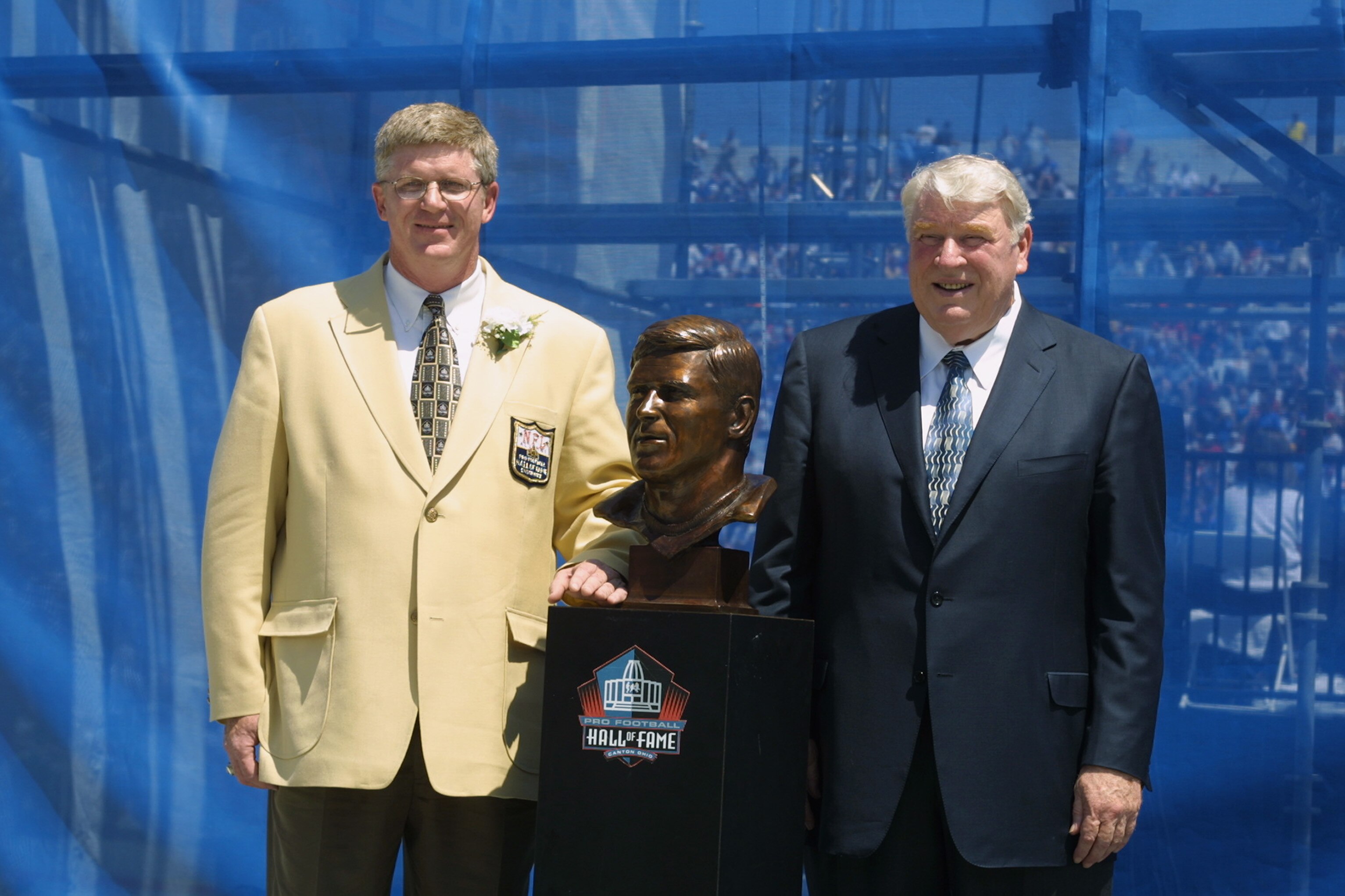 CANTON, OHIO - AUGUST 3:  Dave Casper (left) stands next to his bust with his presenter and former head coach John Madden after his induction into the National Football League Hall of Fame on August 3, 2002 at Fawcett Stadium in Canton, Ohio.  Dave Casper