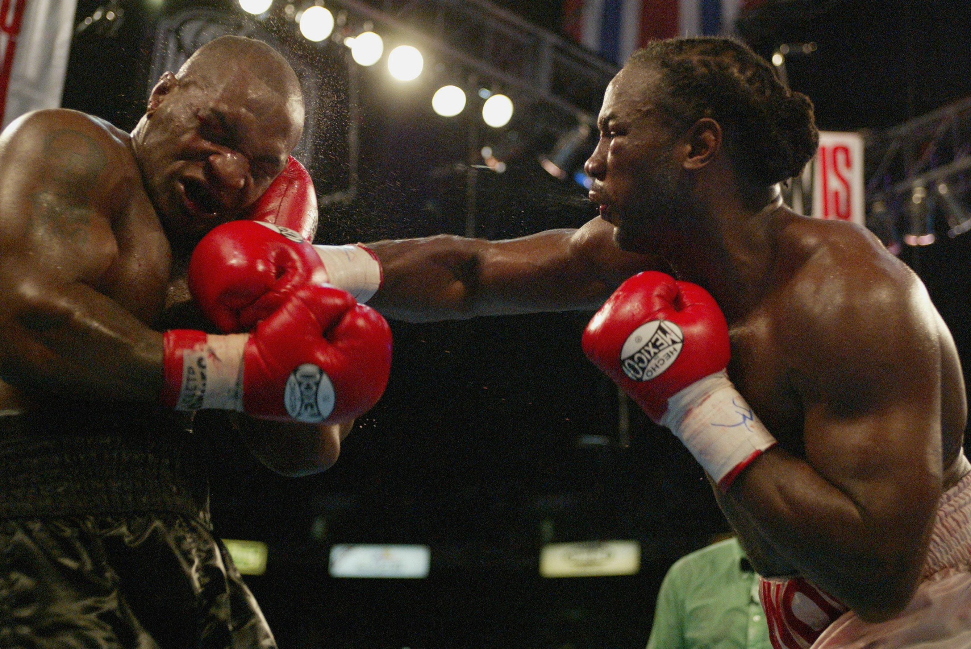 MEMPHIS, TN - JUNE 8:  Lennox Lewis hits Mike Tyson with a right hook in the 8th round during their WBC/IBF heavyweight championship bout on June 8, 2002 at The Pyramid in Memphis, Tennessee.  (Photo by Al Bello/Getty Images)