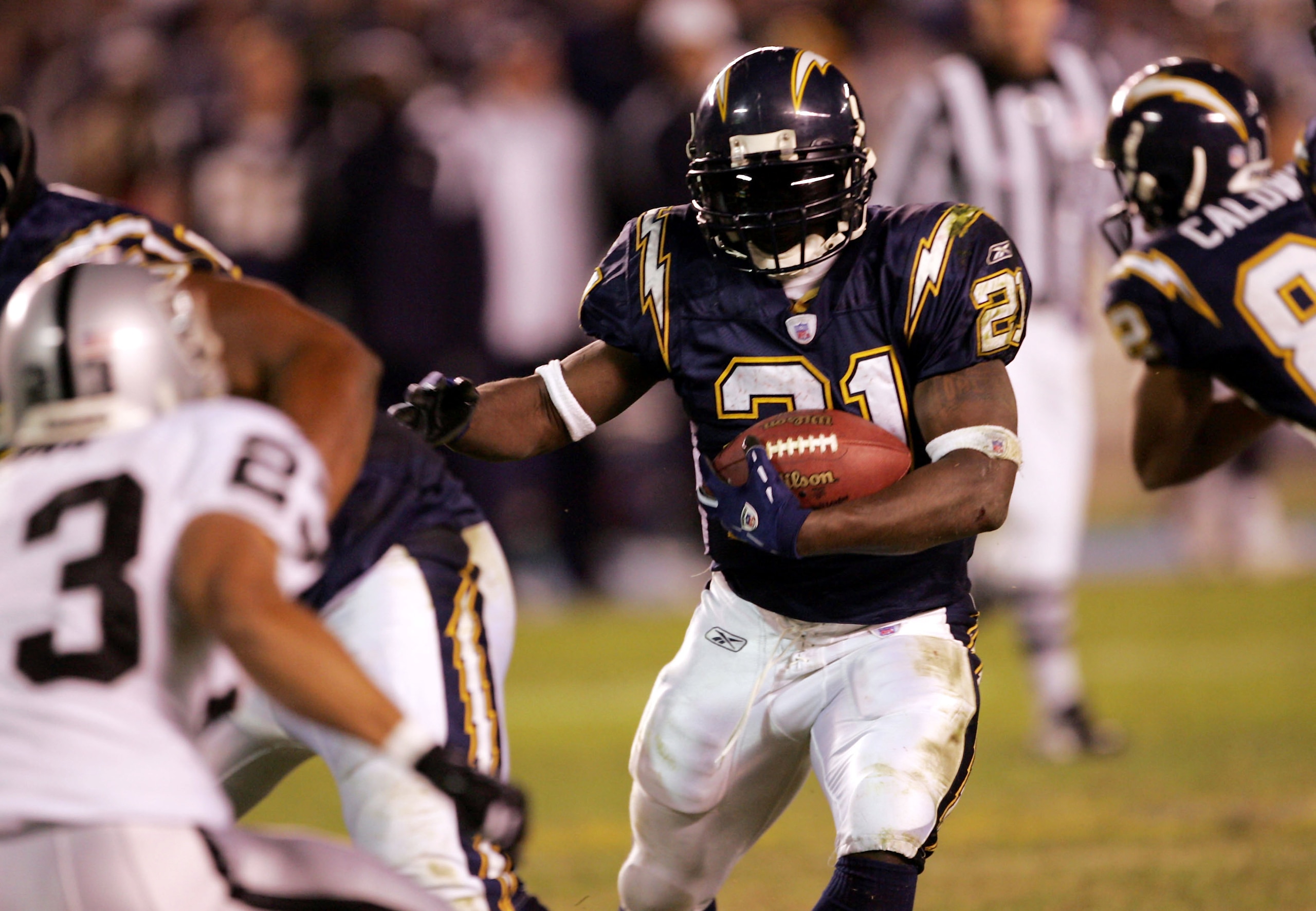 SAN DIEGO - DECEMBER 4: Running back LaDainian Tomlinson #21 of the San Diego Chargers carries the ball against the Oakland Raiders on December 4, 2005 at Qualcomm Stadium in San Diego, California. The Chargers won 34-10. (Photo by Stephen Dunn/Getty Im SAN DIEGO - DECEMBER 4: Running back LaDainian Tomlinson #21 of the San Diego Chargers carries the ball against the Oakland Raiders on December 4, 2005 at Qualcomm Stadium in San Diego, California. The Chargers won 34-10. (Photo by Stephen Dunn/Getty Im