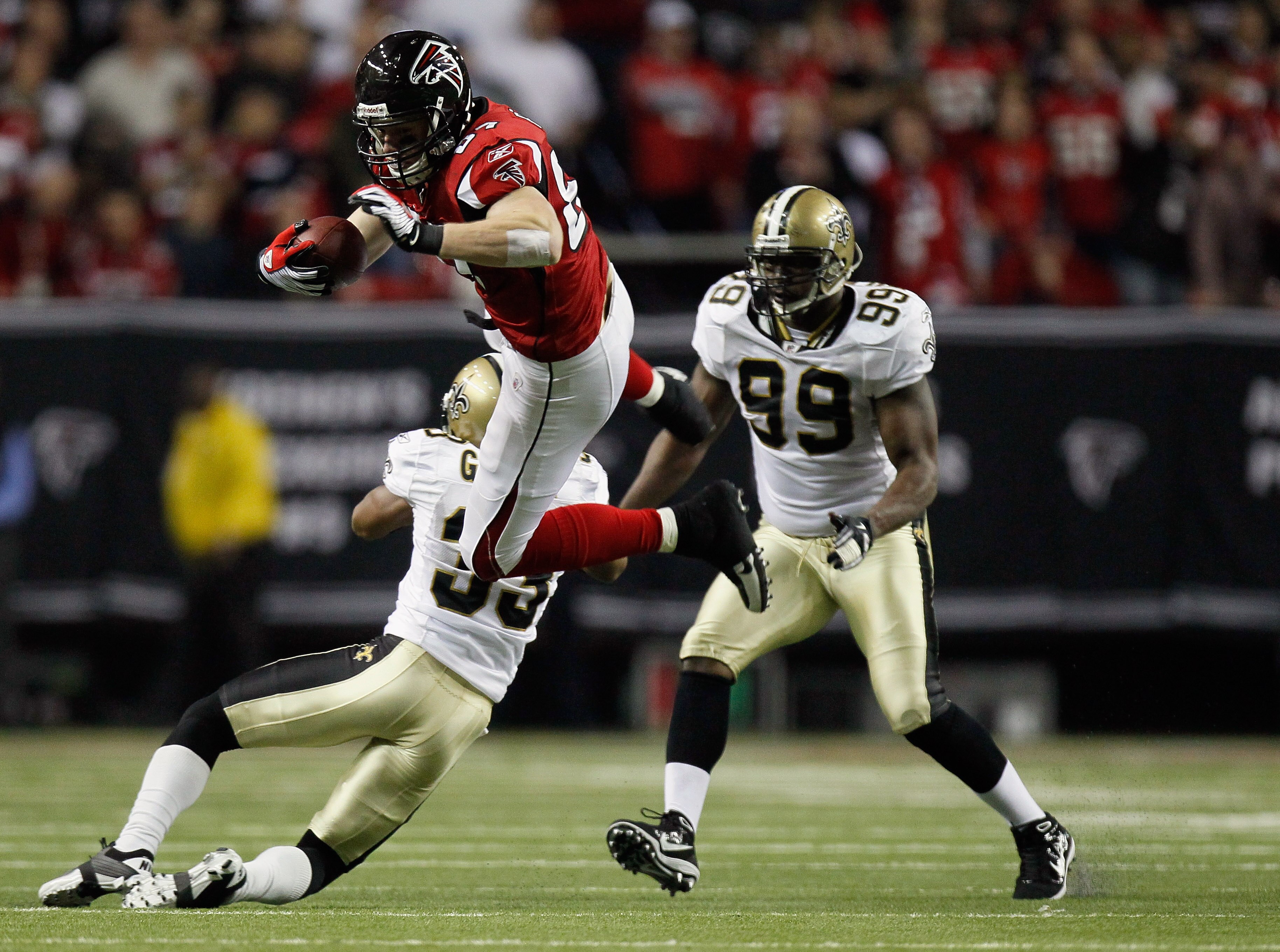 ATLANTA, GA - DECEMBER 27:  Justin Peelle #87 of the Atlanta Falcons goes up and over the tackle of Jabari Greer #33 of the New Orleans Saints during their game at the Georgia Dome on December 27, 2010 in Atlanta, Georgia.  (Photo by Kevin C. Cox/Getty Im