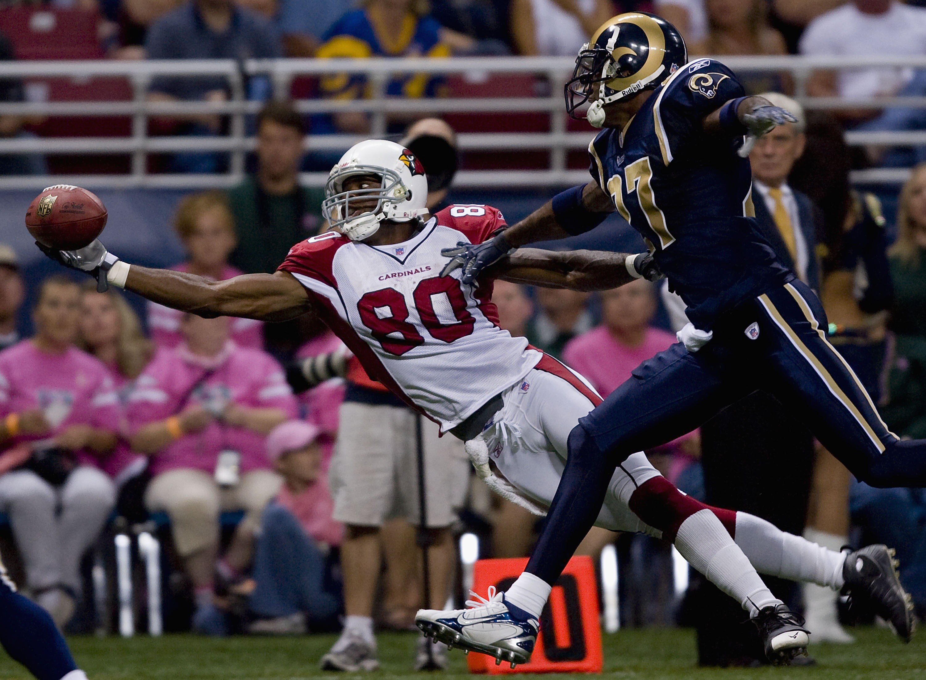 ST. LOUIS, MO - OCTOBER 7:  Bryant Johnson #80 of the Arizona Cardinals attempts to catch a pass against Lenny Walls #27 of the St. Louis Rams at the Edward Jones Dome October 7, 2007 in St. Louis, Missouri. The Cardinals beat the Rams 34-31.  (Photo by D