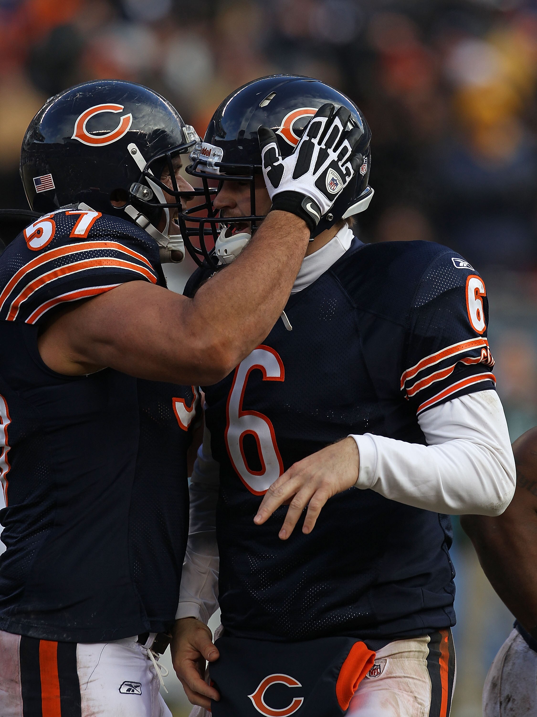 CHICAGO, IL - DECEMBER 26: Jay Cutler #6 of the Chicago Bears gets a hug from teammate Olin Kreutz #57 after running for a touchdown against the New York Jets at Soldier Field on December 26, 2010 in Chicago, Illinois. The Bears defeated the Jets 38-34. (