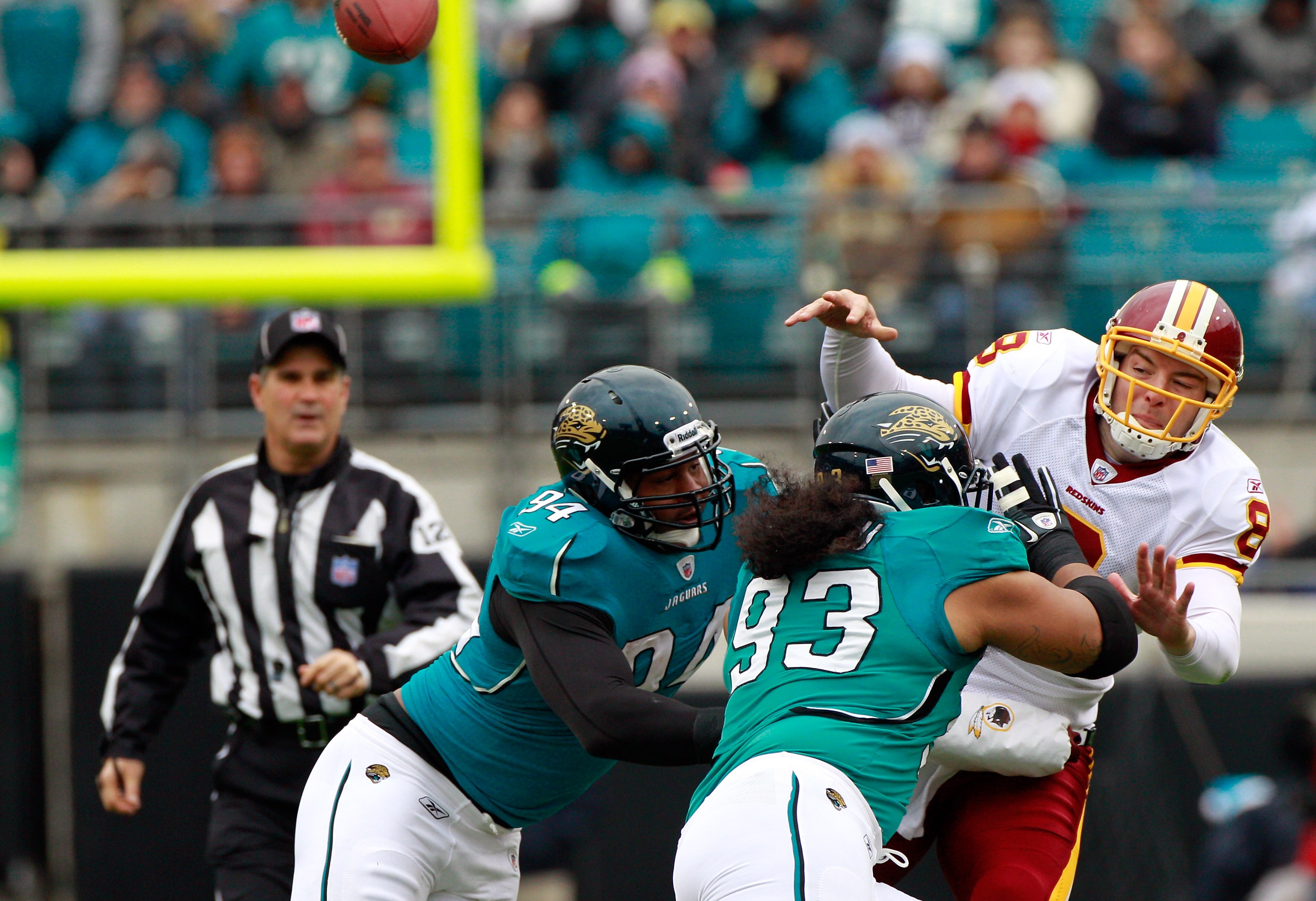 JACKSONVILLE, FL - DECEMBER 26:  Quarterback Rex Grossman #8 of the Washington Redskins is pressured by Tyson Alualu #93 and Jeremy Mincey #94 of the Jacksonville Jaguars during the game at EverBank Field on December 26, 2010 in Jacksonville, Florida.  (P