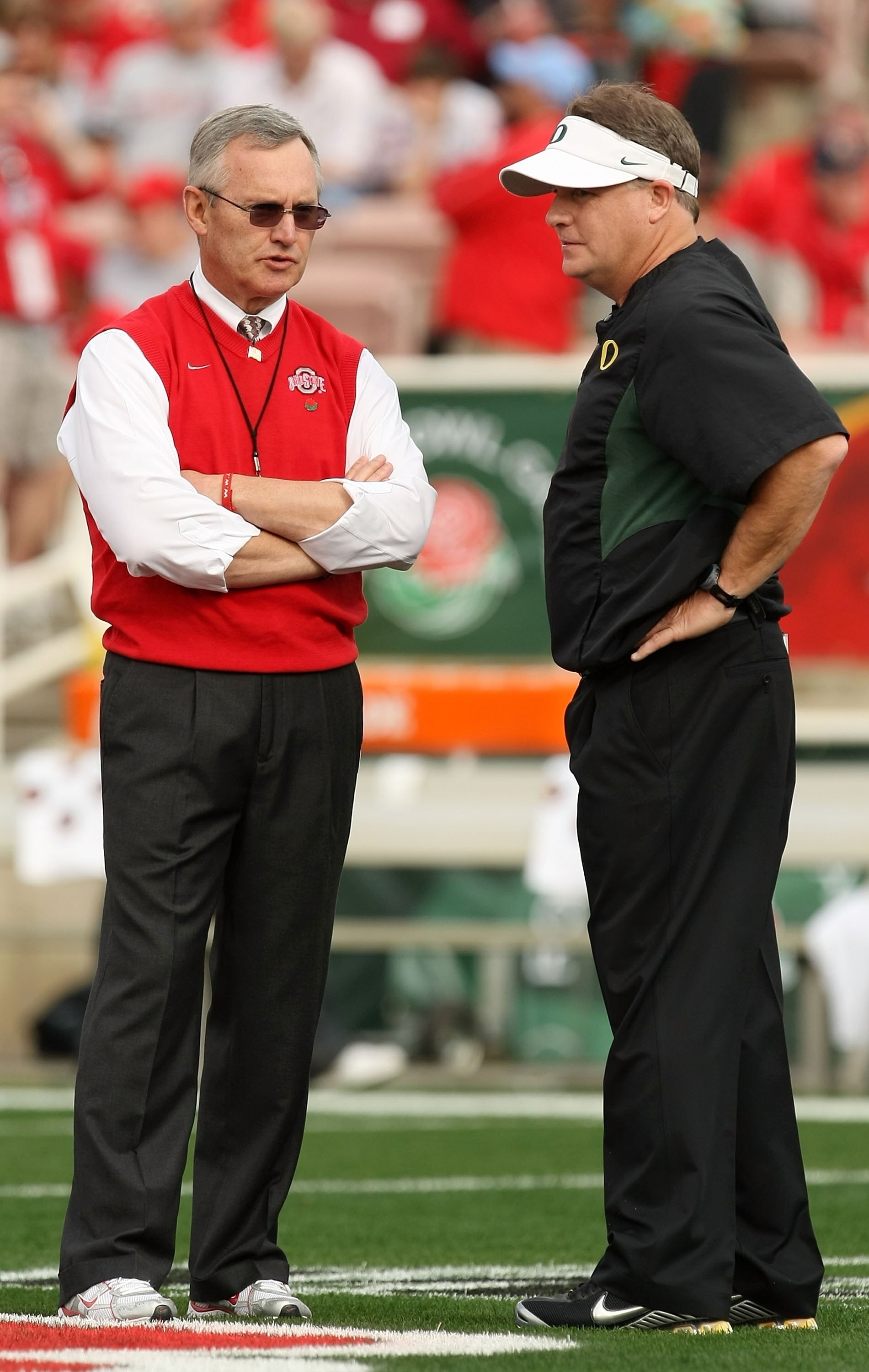 PASADENA, CA - JANUARY 01:  (R-L) Head coach Chip Kelly of the Oregon Ducks talks with head coach Jim Tressel of the Ohio State Buckeyes at the 96th Rose Bowl game on January 1, 2010 in Pasadena, California.  (Photo by Stephen Dunn/Getty Images)