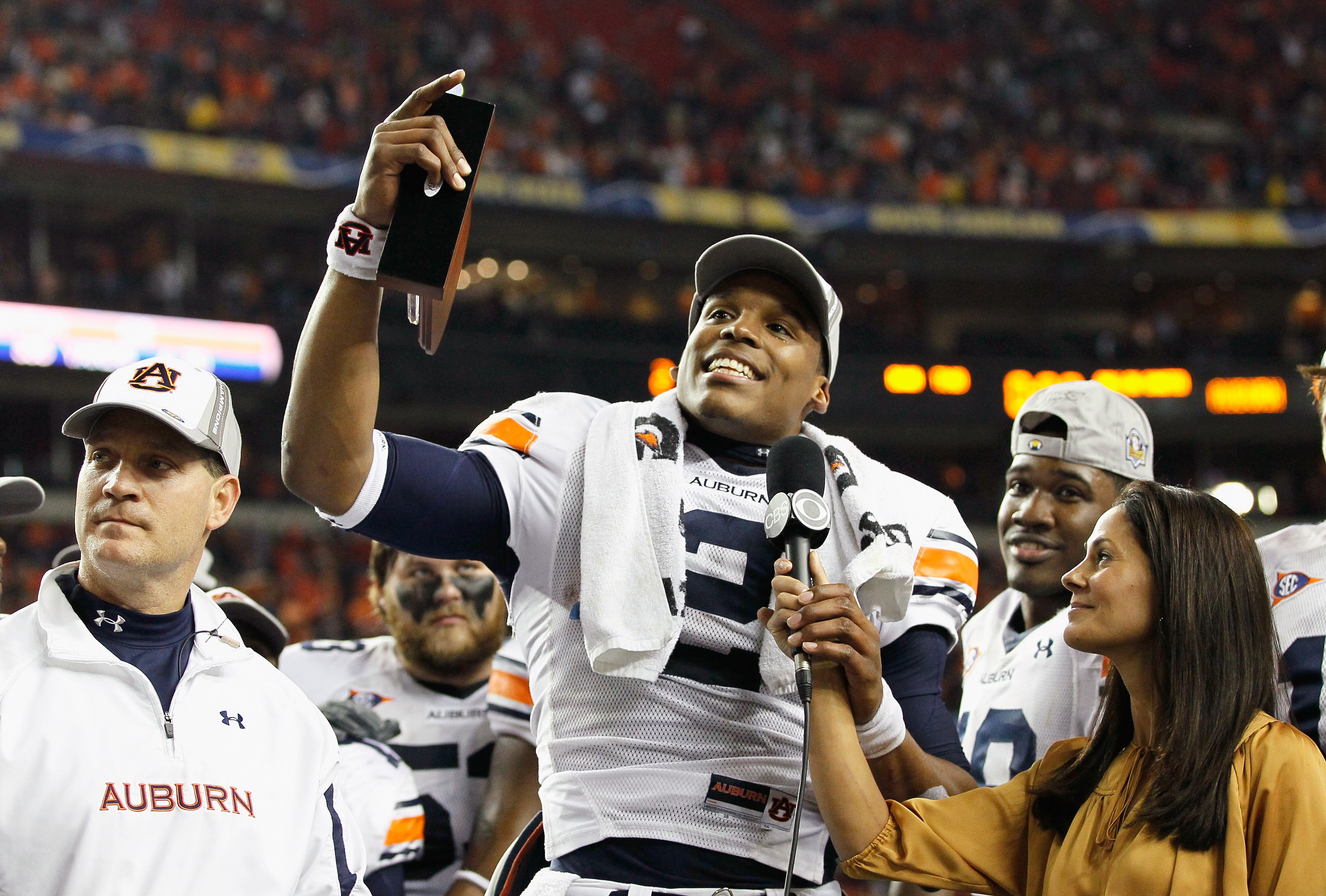 ATLANTA, GA - DECEMBER 04:  Quarterback Cam Newton #2 of the Auburn Tigers talks to CBS sideline reporter Tracy Wolfson after winning the MVP trophy in their 56-17 win over the South Carolina Gamecocks during the 2010 SEC Championship at Georgia Dome on D