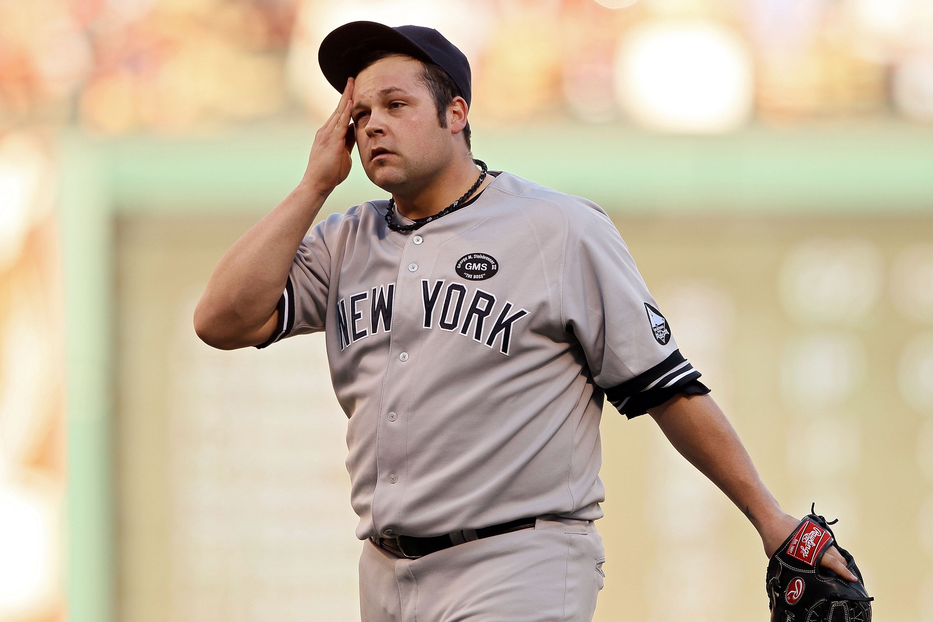 ARLINGTON, TX - OCTOBER 16:  Joba Chamberlain #62 of the New York Yankees wipes his forehead against the Texas Rangers in Game Two of the ALCS during the 2010 MLB Playoffs at Rangers Ballpark in Arlington on October 16, 2010 in Arlington, Texas.  (Photo b