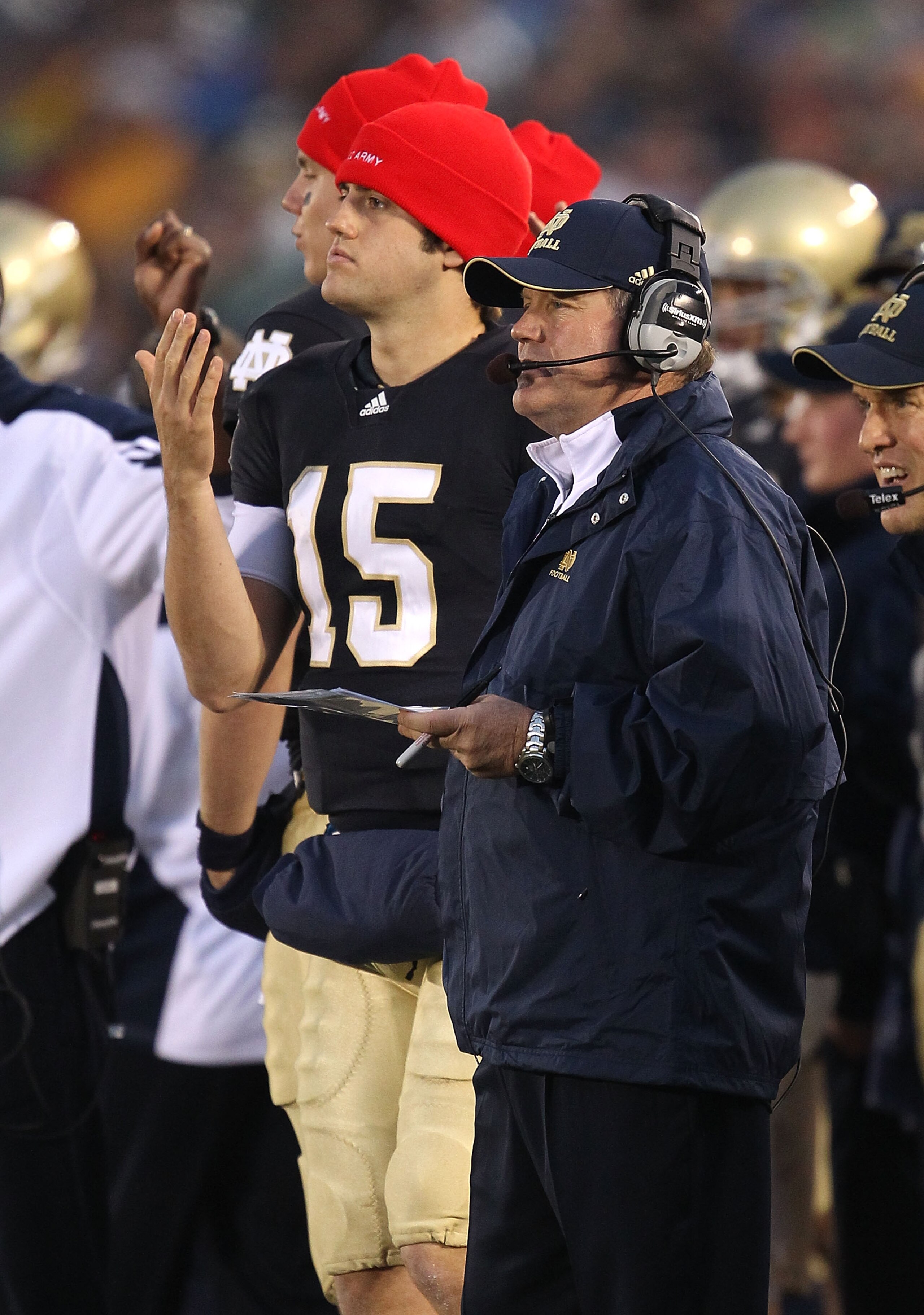 SOUTH BEND, IN - NOVEMBER 13: Head coach Brian Kelly of the Notre Dame Fighting Irish watches as his team takes on the Utah Utes while Brian Castello #15 signals a play at Notre Dame Stadium on November 13, 2010 in South Bend, Indiana. Notre Dame defeated