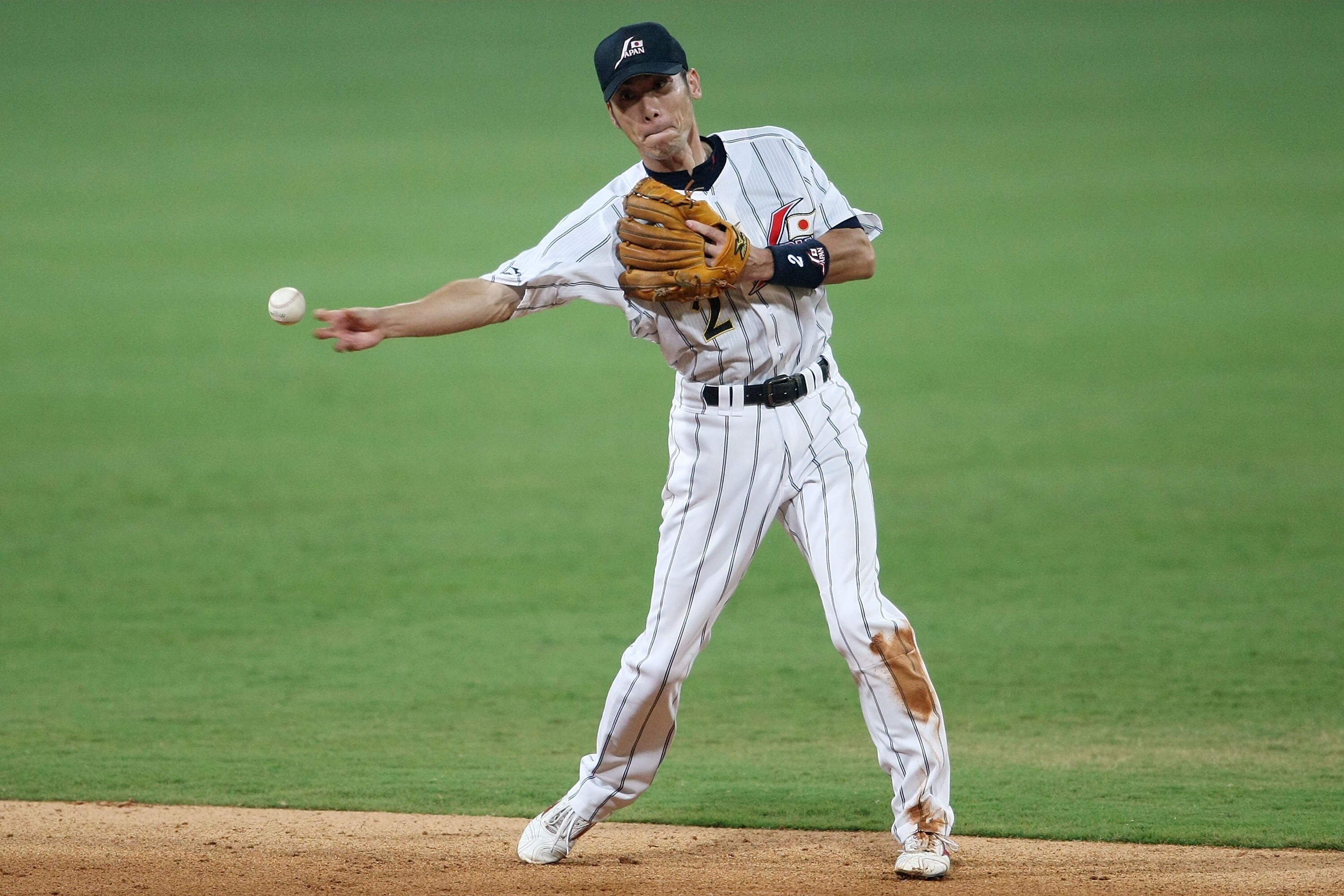 BEIJING - AUGUST 20:  Tsuyoshi Nishioka of Japan throws onto first for the putout against the United States in the baseball event at the Wukesong Baseball Field during Day 12 of the Beijing 2008 Olympic Games on August 20, 2008 in Beijing, China.  (Photo