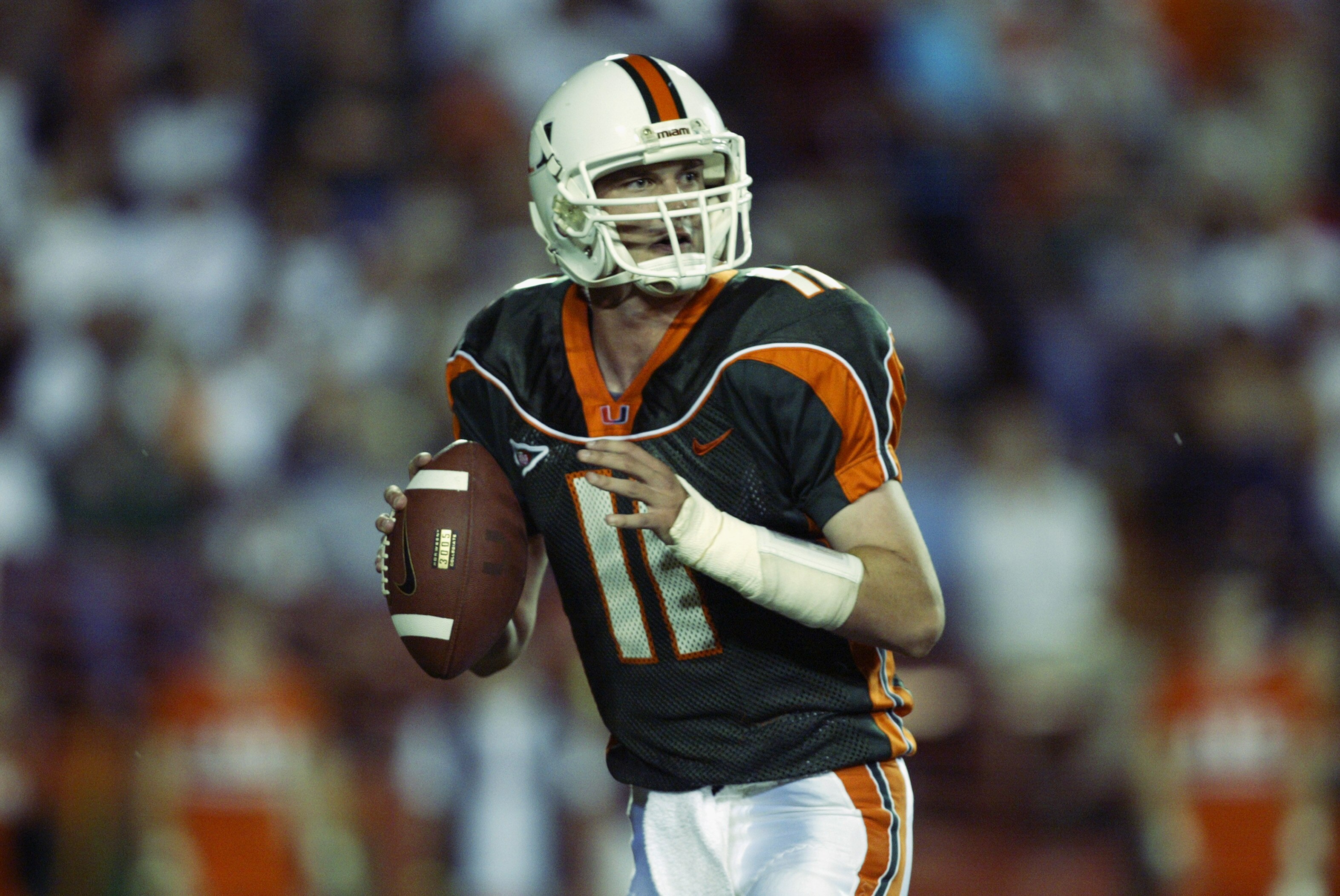 MIAMI, FL - NOVEMBER 21:  Quarterback Ken Dorsey #11 of the University of Miami looks for an open receiver against the University of Pittsburgh during the game at the Orange Bowl on November 21, 2002 in Miami, Florida.  (Photo by Andy Lyons/Getty Images)