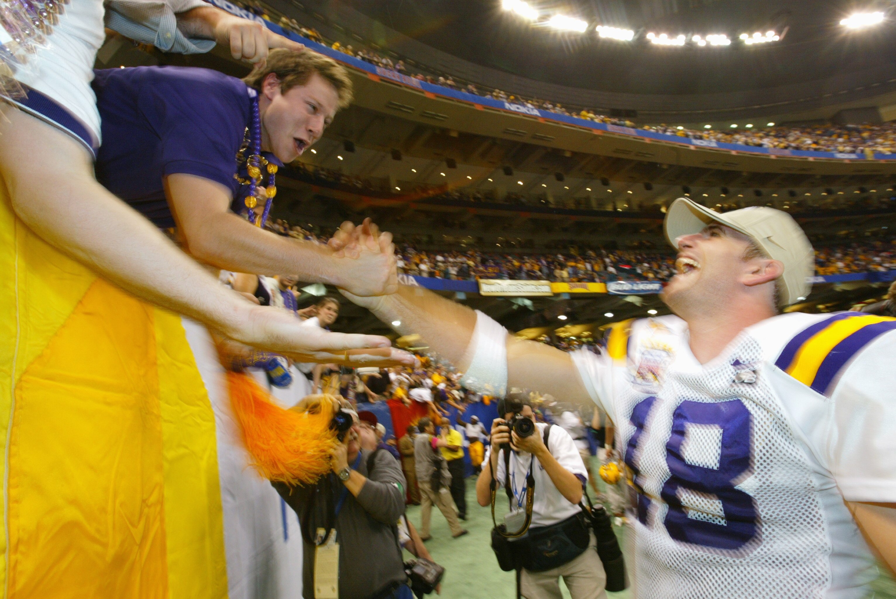 NEW ORLEANS - JANUARY 4:  Quarterback Matt Mauck #18 of the Louisiana State University Tigers greets fans before the National Championship Nokia Sugar Bowl game against the University of Oklahoma Sooners at the Louisiana Superdome on January 4, 2004 in Ne