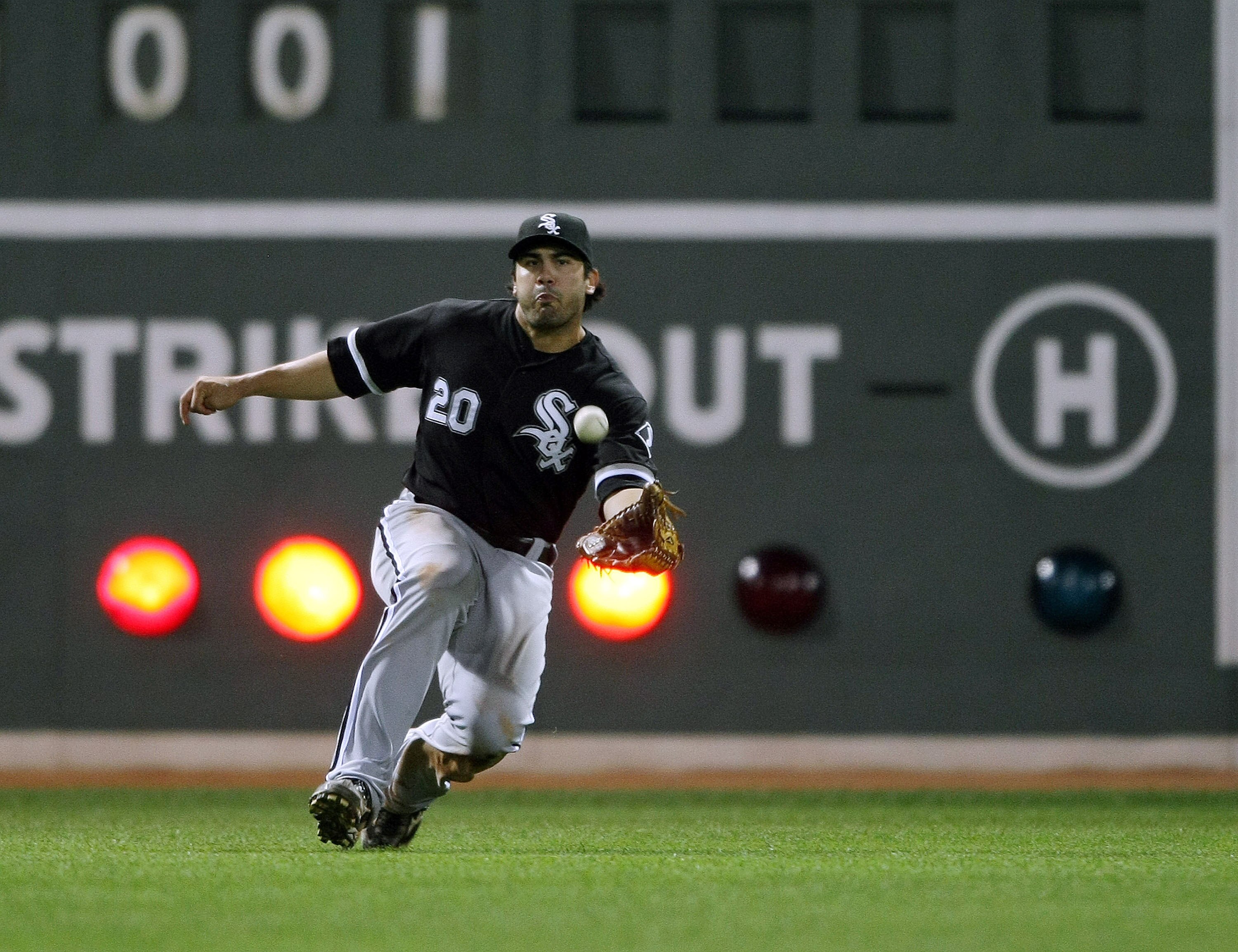 BOSTON - AUGUST 26:  Carlos Quentin #20 of the Chicago White Sox makes the catch for out on a hit by Casey Kotchman of the Boston Red Sox on August 26, 2009 at Fenway Park in Boston, Massachusetts.  (Photo by Elsa/Getty Images)