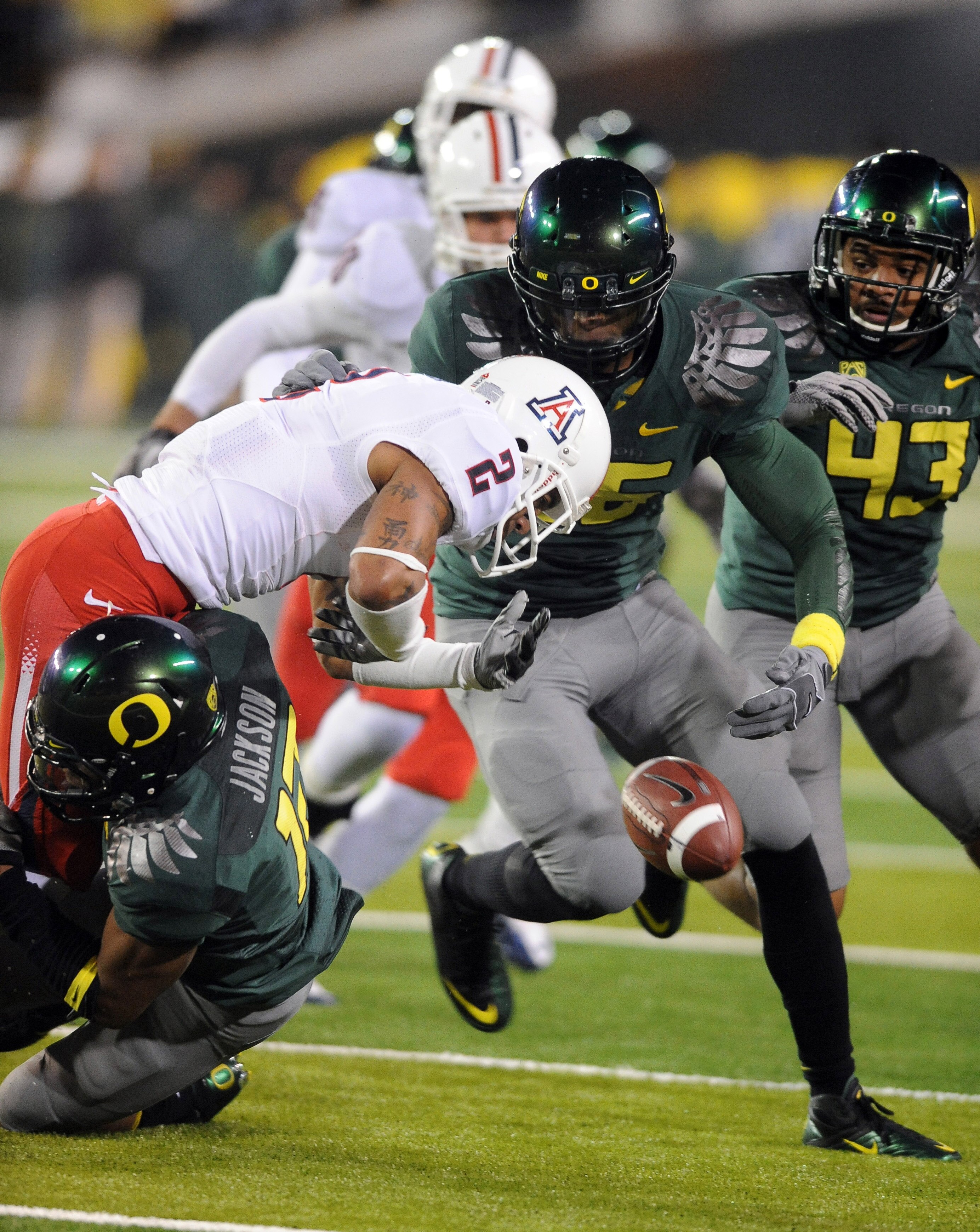EUGENE, OR - NOVEMBER 26: Defensive back Brian Jackson #12 of the Oregon Ducks hits running back Mike Turner #2 of the Arizona Wildcats in the fourth quarter of the game at Autzen Stadium on November 26, 2010 in Eugene, Oregon. The Ducks won the game 48-2