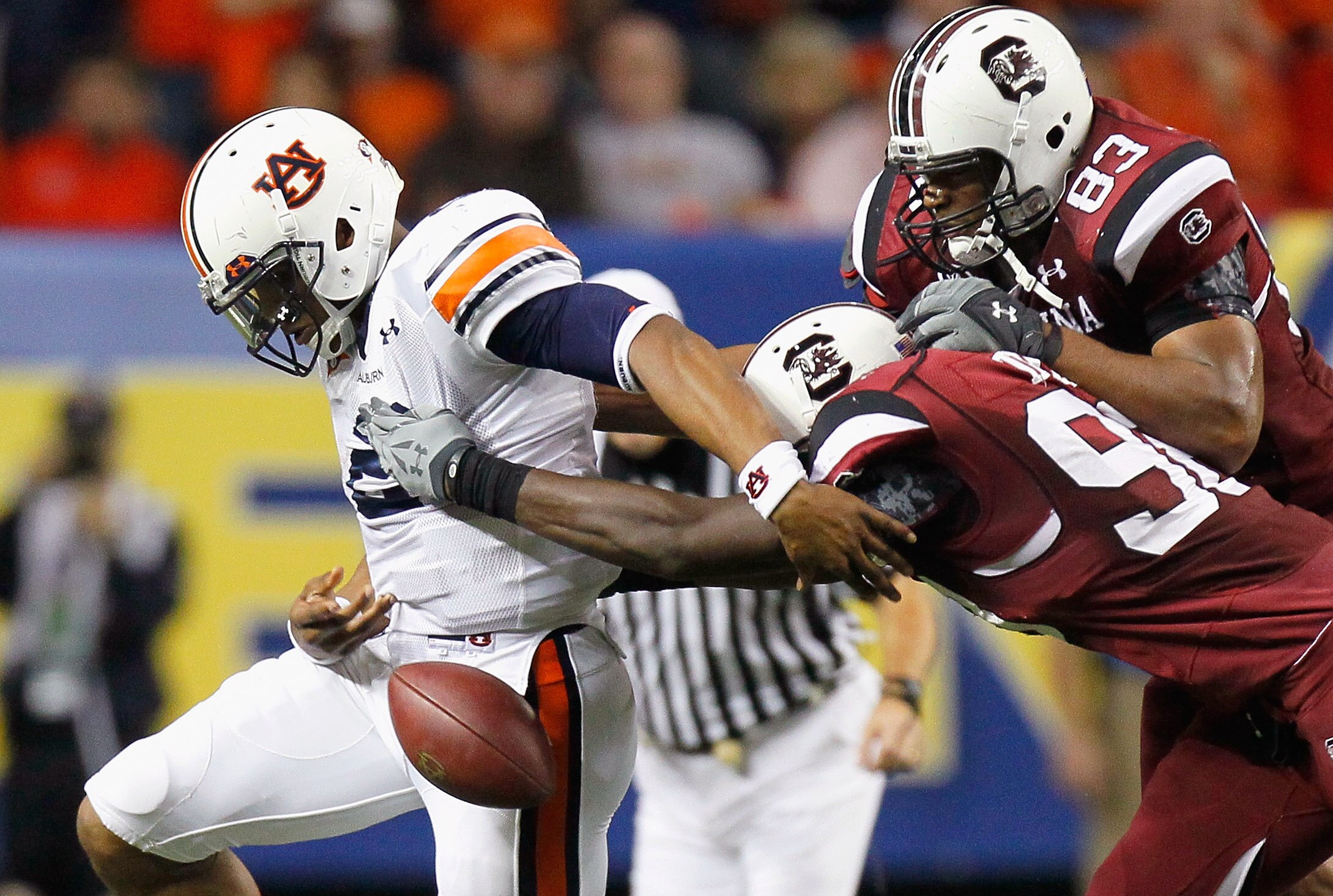 ATLANTA, GA - DECEMBER 04:  Devin Taylor #98 and Cliff Matthews #83 of the South Carolina Gamecocks force a fumble by quarterback Cam Newton #2 of the Auburn Tigers during the 2010 SEC Championship at Georgia Dome on December 4, 2010 in Atlanta, Georgia.