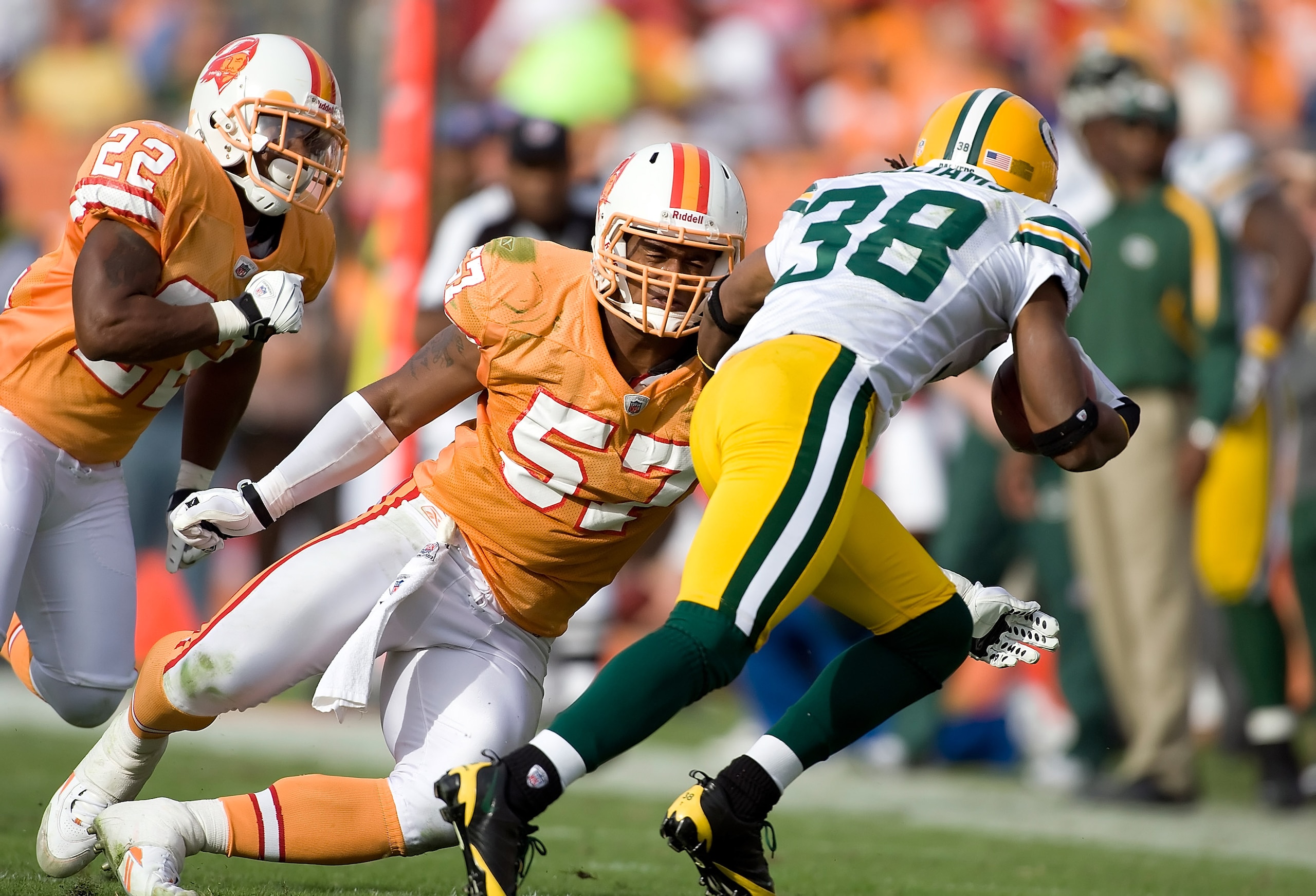 TAMPA, FL - NOVEMBER 08:  Linebacker Adam Hayward #57 of the Tampa Bay Buccaneers tackles return man Tramon Williams #38 of the Green Bay Packers during the game at Raymond James Stadium on November 8, 2009 in Tampa, Florida.  (Photo by J. Meric/Getty Ima