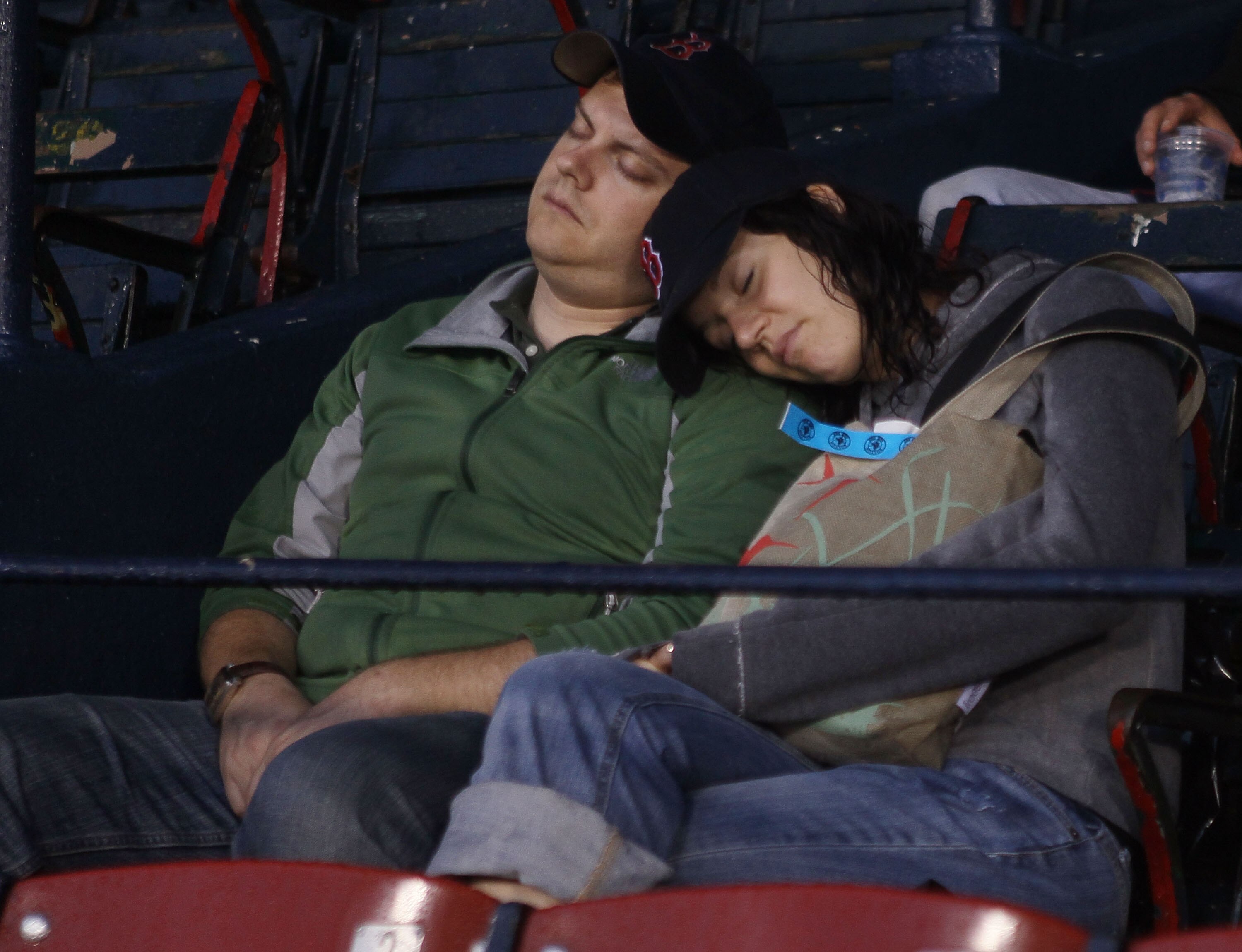BOSTON - AUGUST 24:  Fans take a nap as they wait for an announcement about the game between the Seattle Mariners and the Boston Red Sox on August 24, 2010 at Fenway Park in Boston, Massachusetts. Tonight's game has been postponed and the teams will play