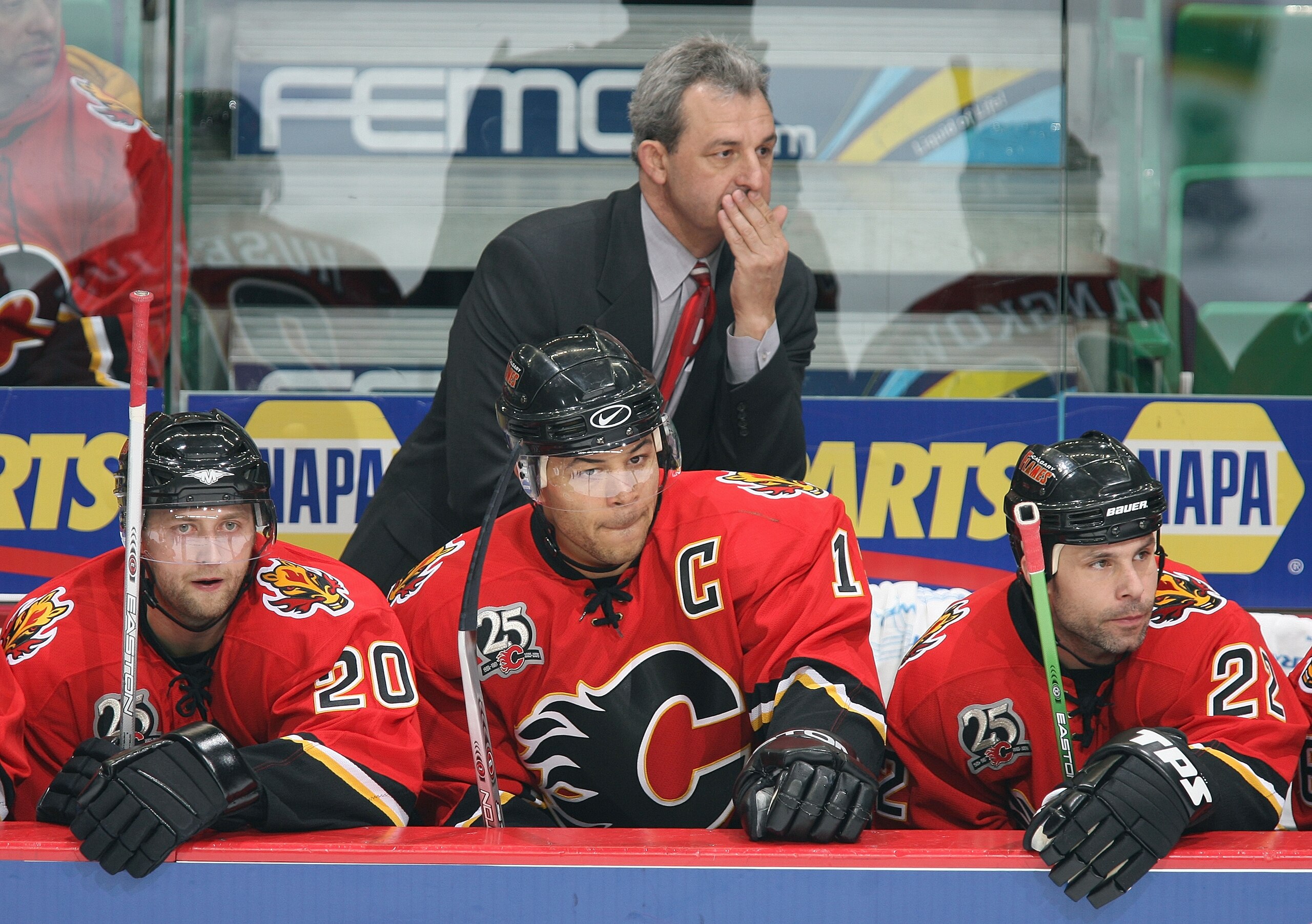 CALGARY, CANADA - DECEMBER 17:  (L-R) Kristian Huselius #20, Jarome Iginla #12, Head Coach Darryl Sutter and Daymond Langkow #22 of the Calgary Flames look on from the bench during their NHL game against the Boston Bruins at Pengrowth Saddledome on Decemb