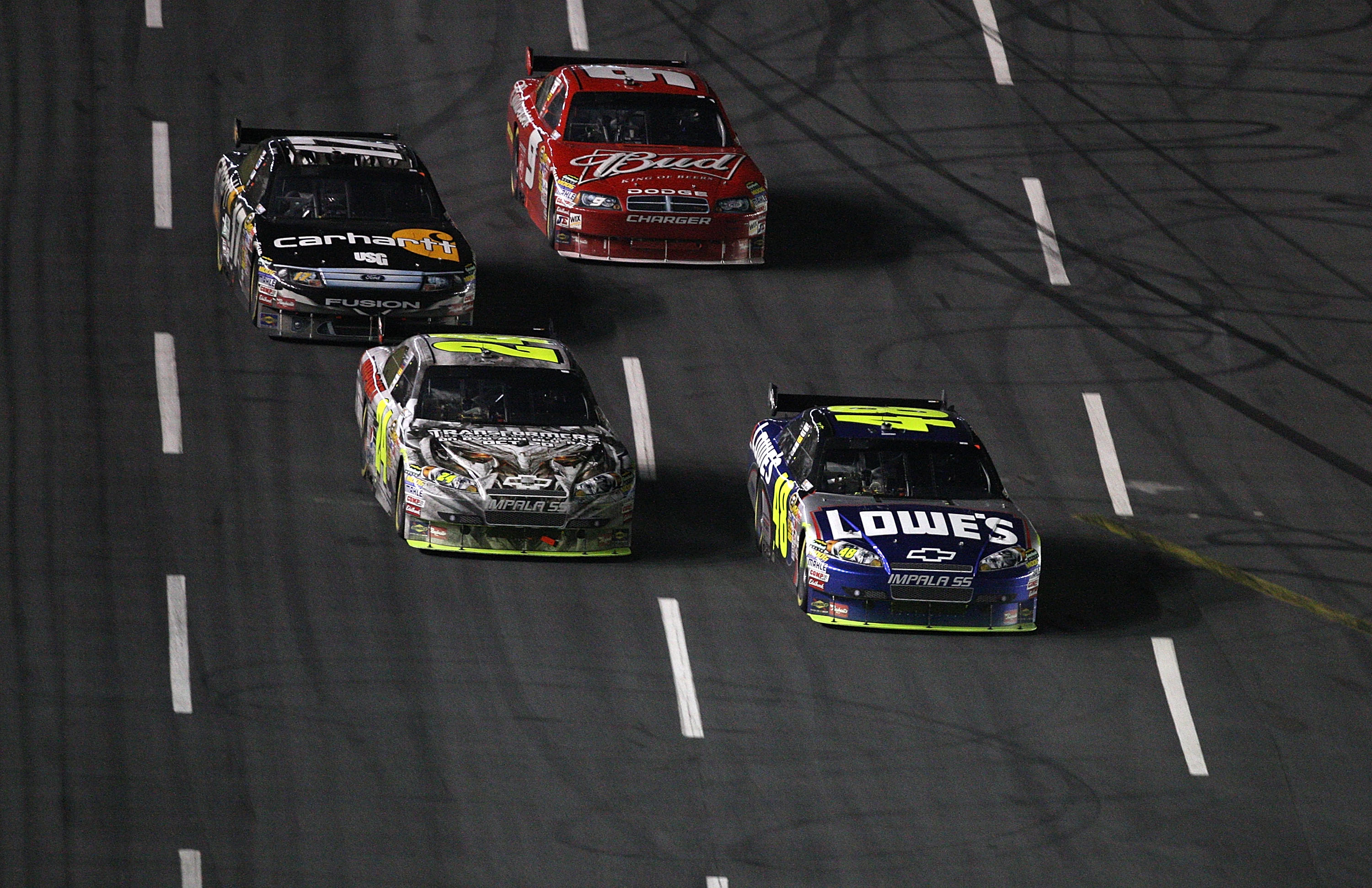 CONCORD, NC - OCTOBER 17:  Jimmie Johnson, driver of the #48 Lowe's Chevrolet, races Jeff Gordon, driver of the #24 DuPont/Transformers 2 Chevrolet, Matt Kenseth, driver of the #17 Carhartt Ford, and Kasey Kahne, driver of the #9 Bedweiser Dodge, during t
