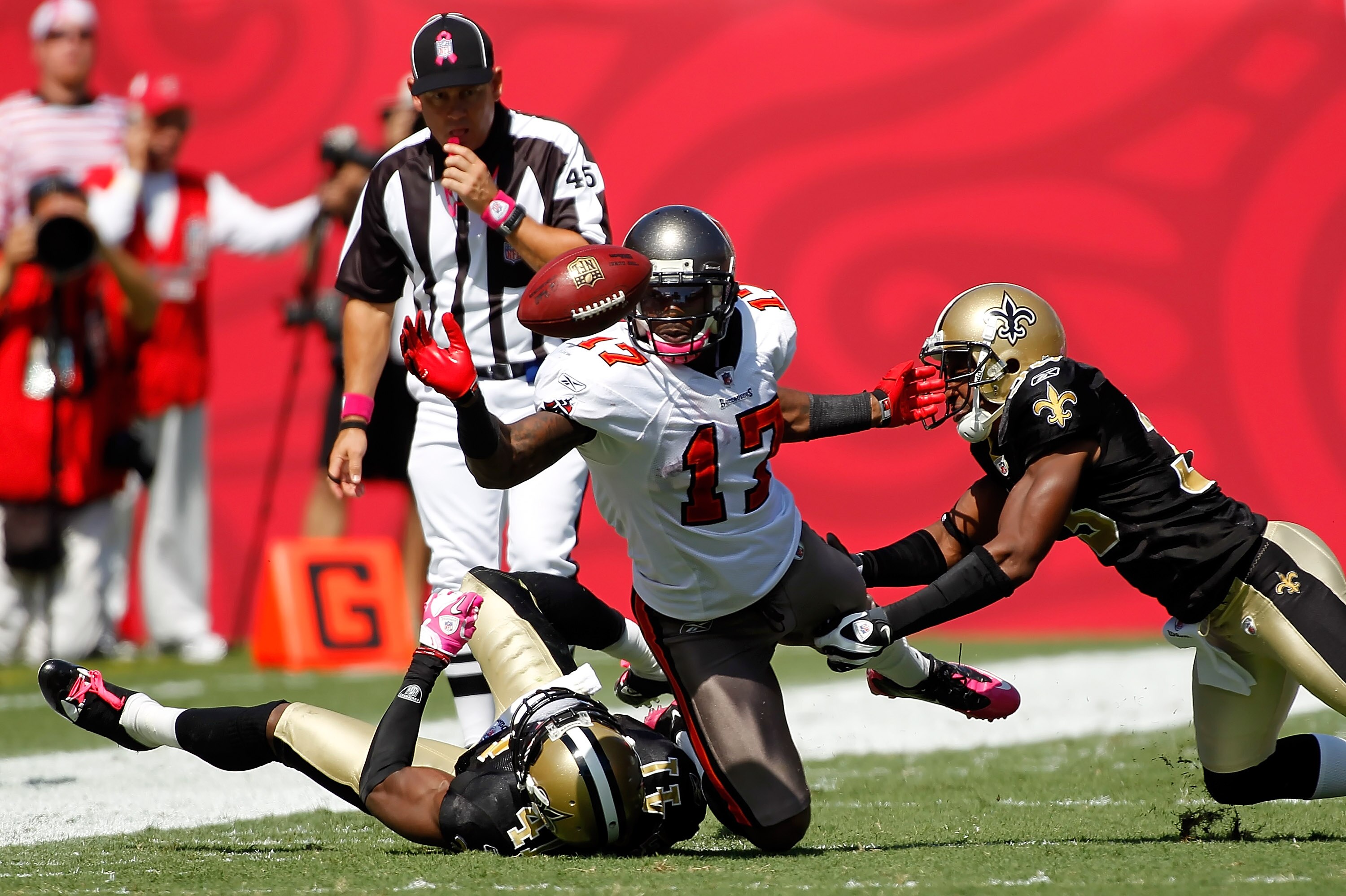 TAMPA, FL - OCTOBER 17:  Defenders Roman Harper #41 and Jabari Greer #33 of the New Orleans Saints tackle Arrelious Benn #17 of the Tampa Bay Buccaneers as he fumbles during the game at Raymond James Stadium on October 17, 2010 in Tampa, Florida.  (Photo