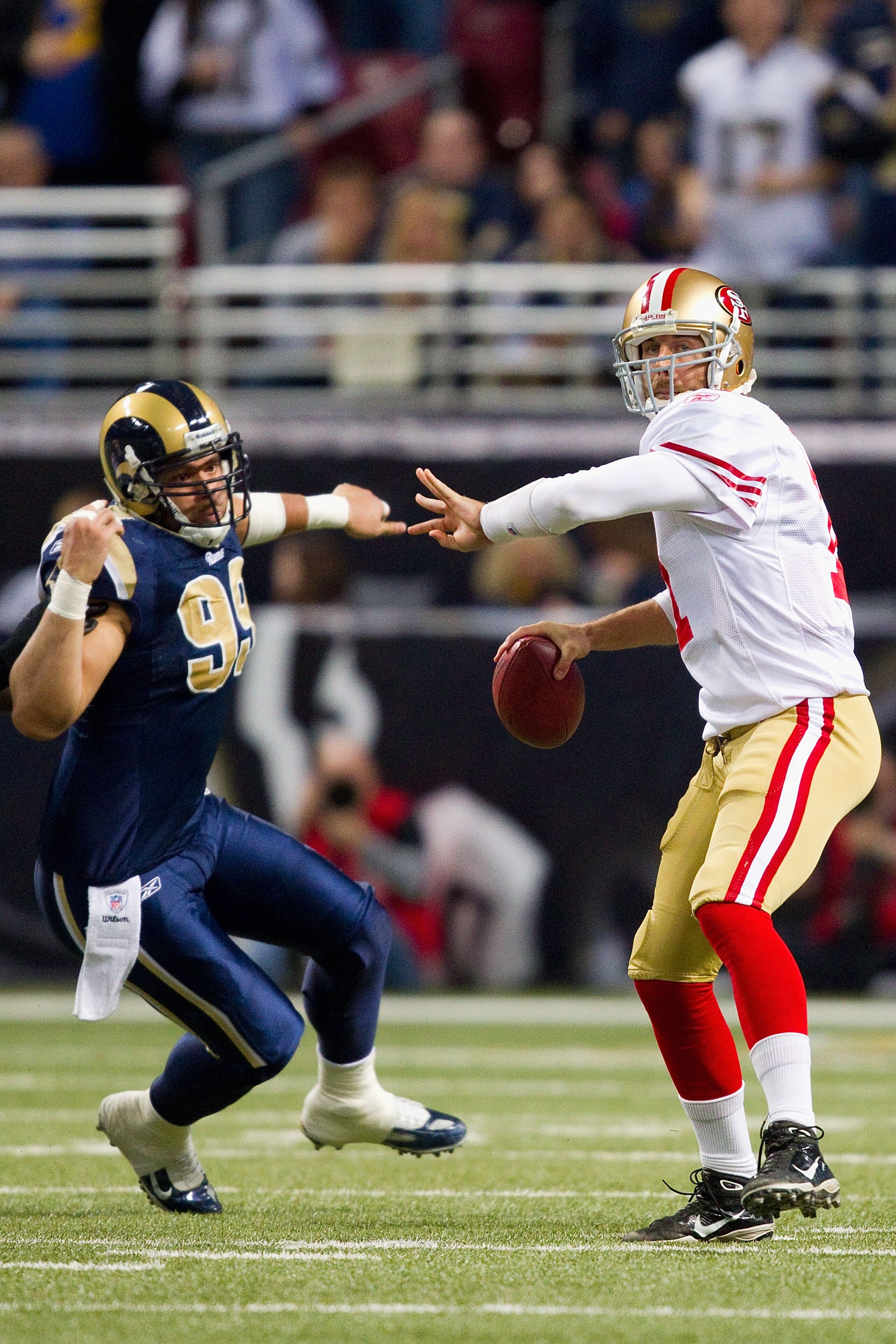 ST. LOUIS, MO - DECEMBER 26: Alex Smith #11 of the San Francisco 49ers passes the ball against C.J. Ah You #99 of the St. Louis Rams at the Edward Jones Dome on December 26, 2010 in St. Louis, Missouri. The Rams beat the 49ers 25-17. (Photo by Dilip Vishw
