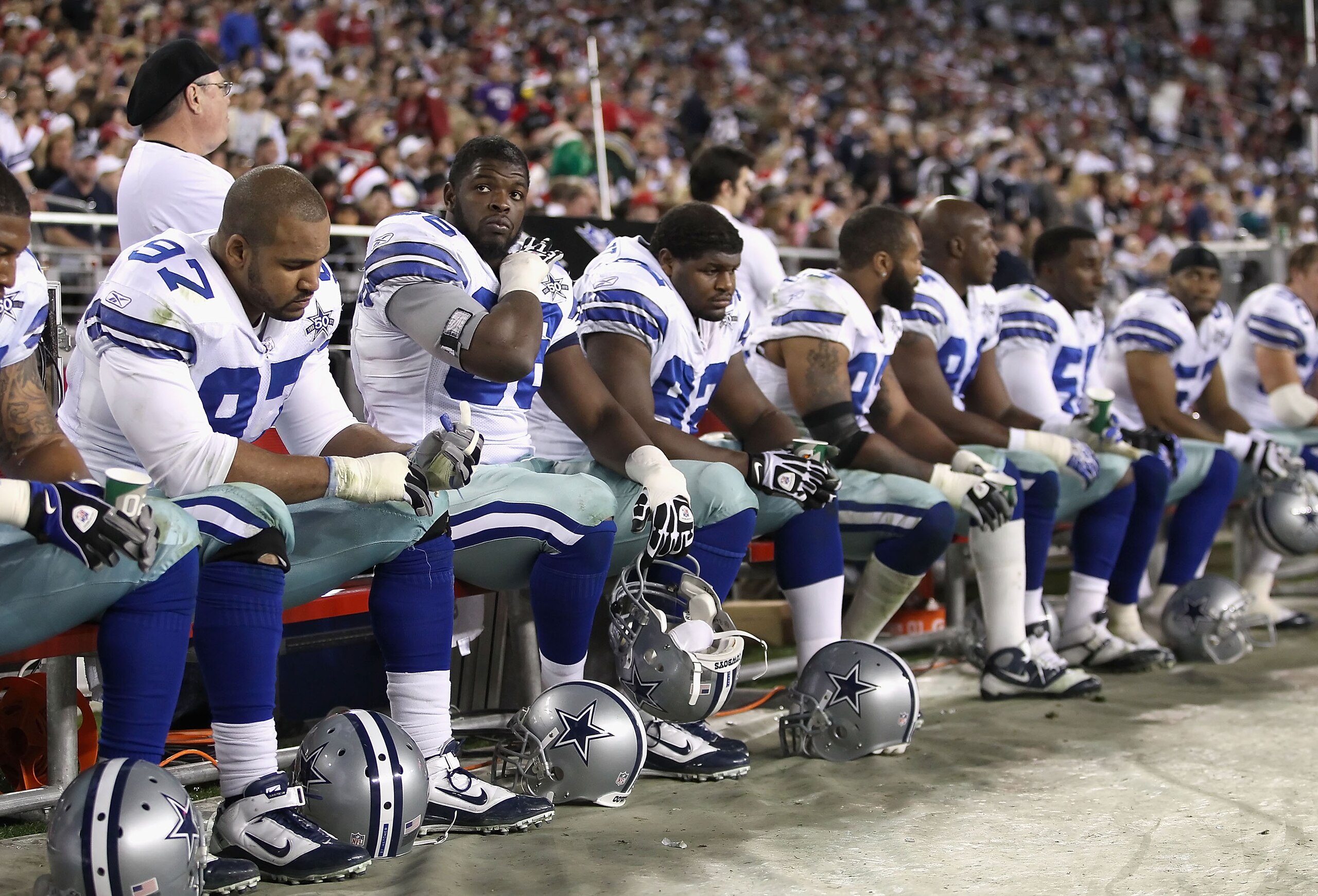 GLENDALE, AZ - DECEMBER 25:  (2nd from left) Clifton Geathers #66 of the Dallas Cowboys looks up from the bench during the NFL game against the Arizona Cardinals at the University of Phoenix Stadium on December 25, 2010 in Glendale, Arizona. The Cardinals