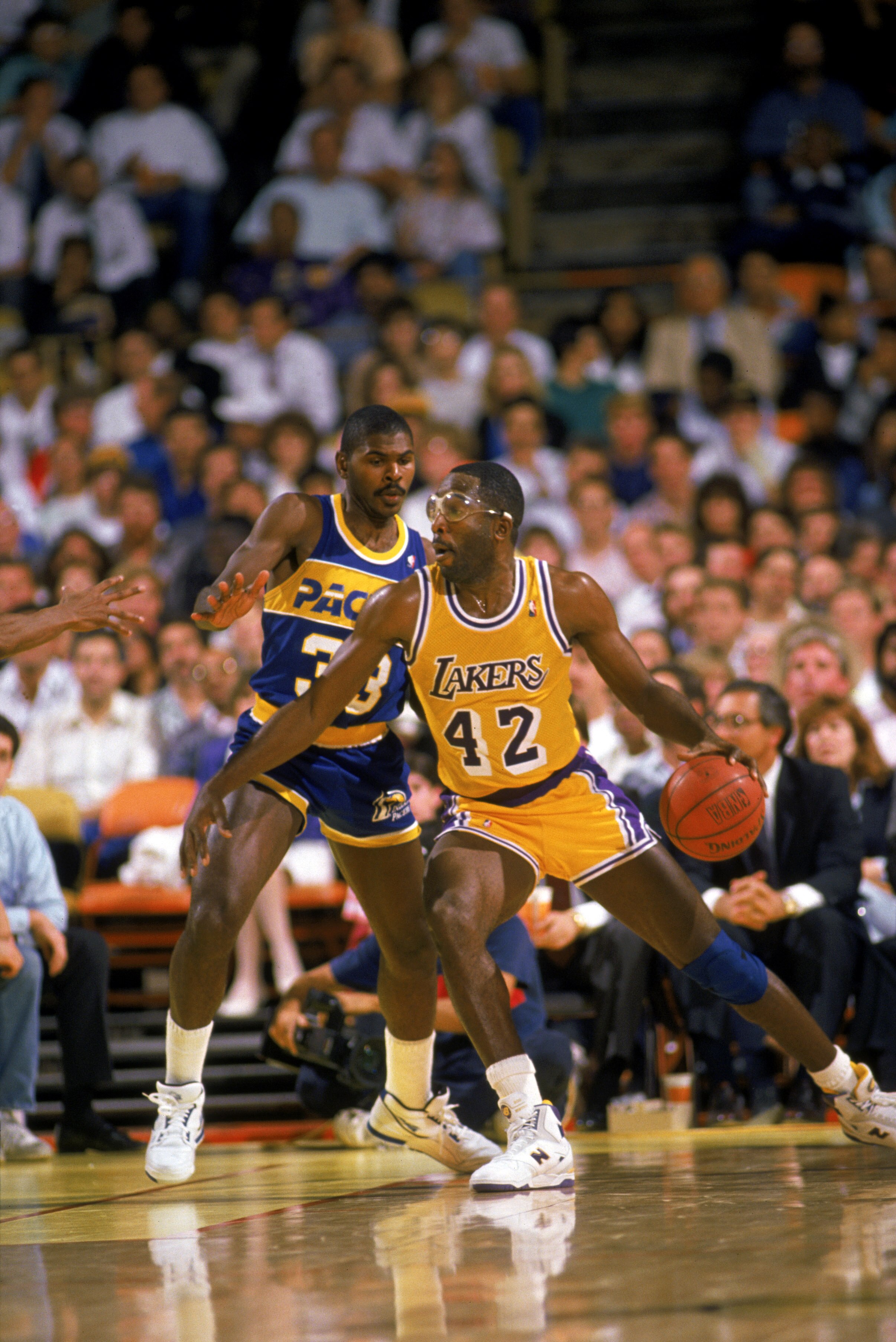 LOS ANGELES - 1989:  James Worthy #42 of the Los Angeles Lakers dribbles the ball in the post during an NBA game against the Indiana Pacers at the Great Western Forum in Los Angeles, California in 1989. (Photo by: Mike Powell/Getty Images)